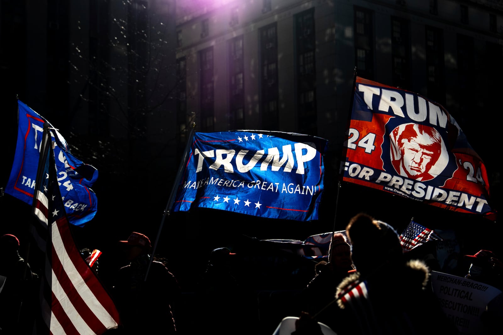 FILE - Demonstrators wave MAGA flags outside the Manhattan criminal court following the sentencing in President-elect Donald Trump's hush money case, in New York, Jan. 10, 2025. (AP Photo/Julia Demaree Nikhinson, File)