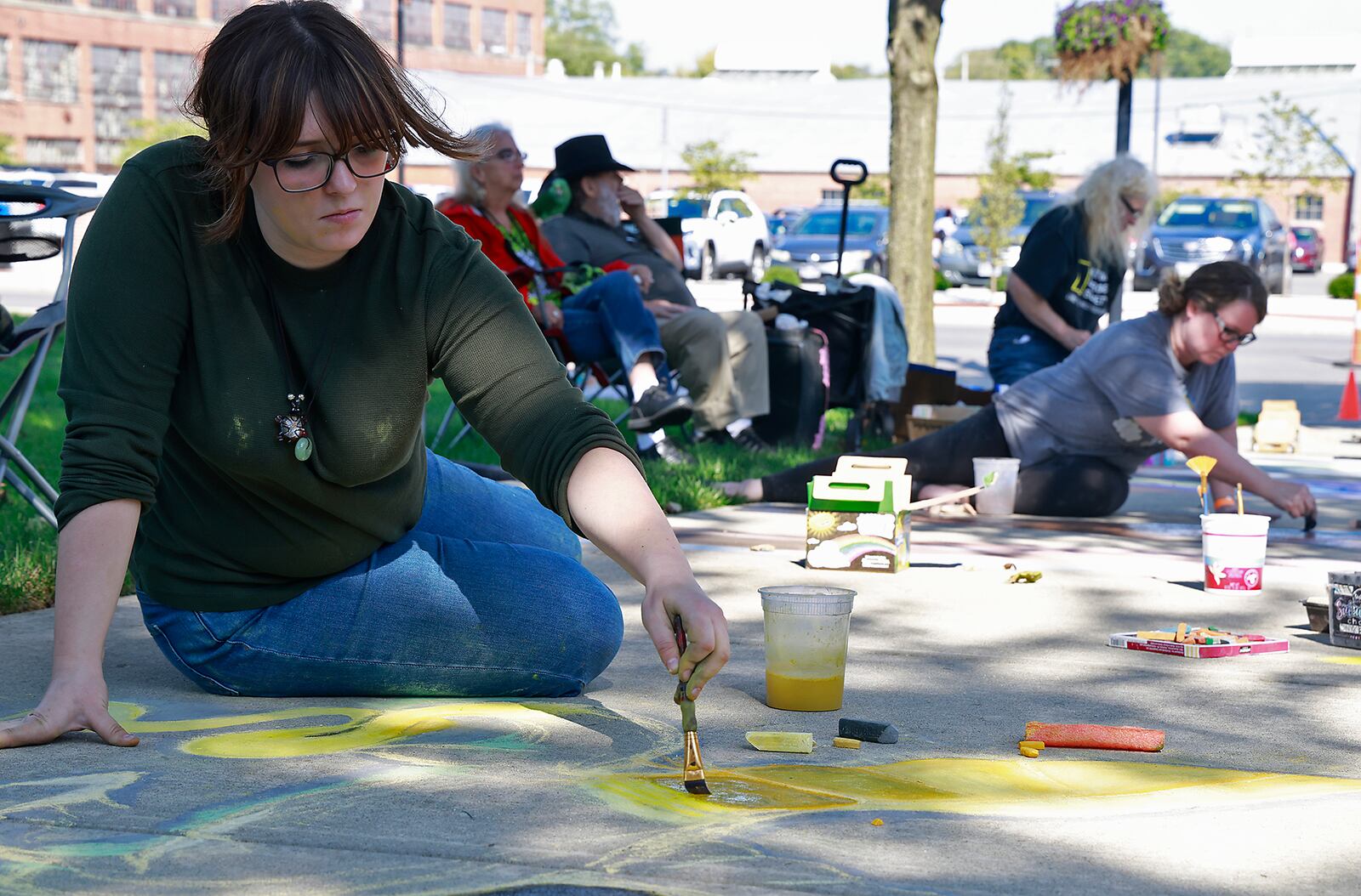 Corinne Fisher works on her chalk art Saturday, Oct. 5, 2024 during ChalkFest at National Road Commons Park in downtown Springfield. Dozens of amateur and professional artists from around the area showed off their skill on the sidewalks and streets around the park. ChalkFest also featured live music, food trucks and creative activities for the kids. BILL LACKEY/STAFF