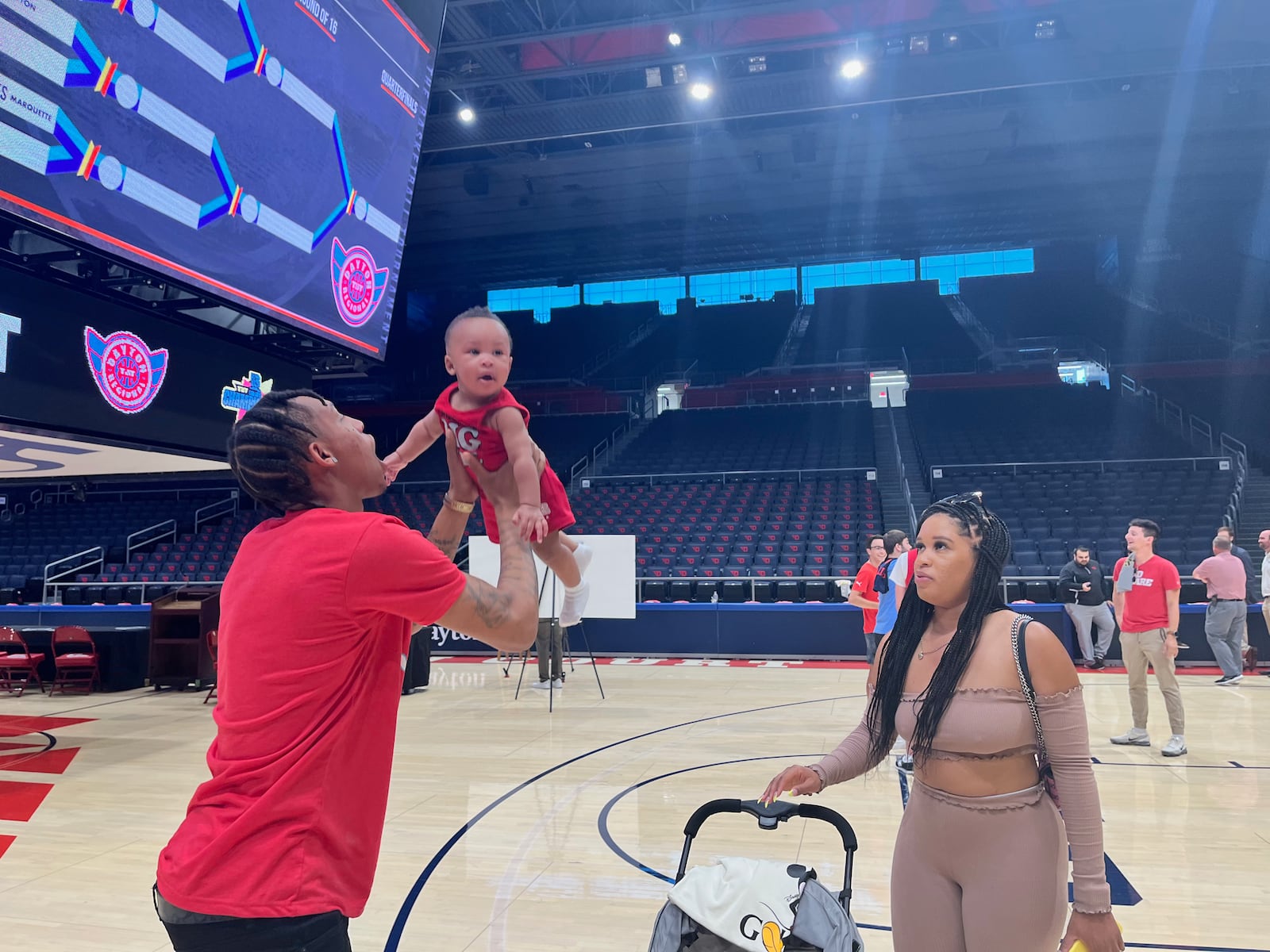 The Red Scare's Joe Thomasson holds his son  Jesiah (7 months) as his fiancée, LaDreshay, watches after a press conference for The Basketball Tournament on Wednesday, June 22, 2022, at UD Arena in Dayton. David Jablonski/Staff