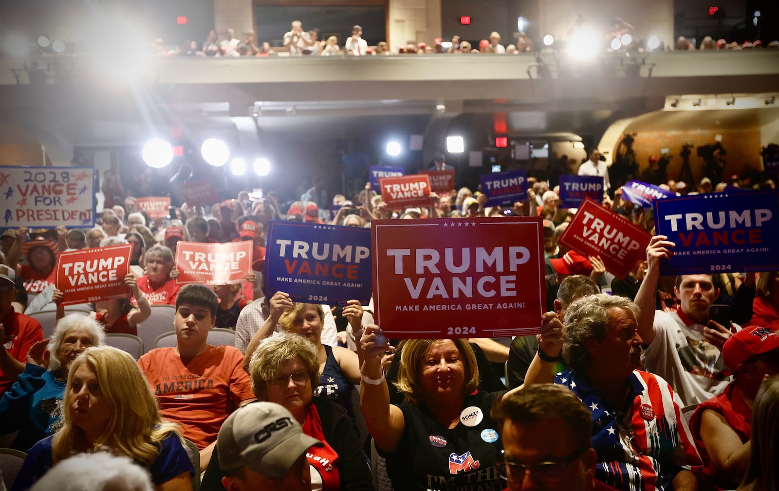 Supporters of Republican vice presidential candidate and U.S. Sen. JD Vance hold Trump-Vance signs during a political rally at Middletown High School on Monday, July 22, 2024. MARSHALL GORBY / STAFF