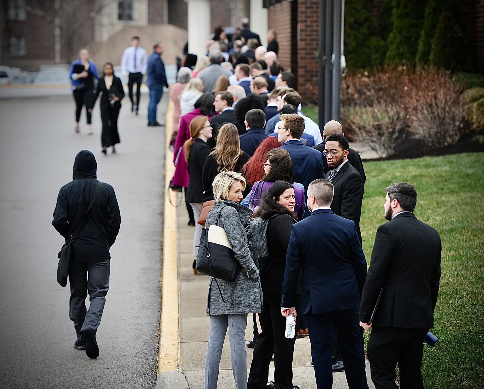 Jobseekers line up outside the Holiday Inn in Fairborn on Wednesday, March 22, 2023, for the one-day Air Force Life Cycle Management Center hiring event. AFLCMC is based at Wright-Patterson Air Force Base, home to some 35,000 military and civilian employees. MARSHALL GORBY \STAFF