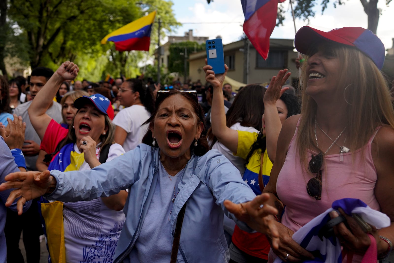 Supporters of Venezuela's opposition leader Edmundo Gonzalez Urrutia react as he walks outside the government residence in Montevideo, Uruguay, Saturday, Jan. 4, 2025. Gonzalez, who claims he won the 2024 presidential election and is recognized by some countries as the legitimate president-elect, traveled from exile in Madrid to Argentina and Uruguay. (AP Photo/Matilde Campodonico)