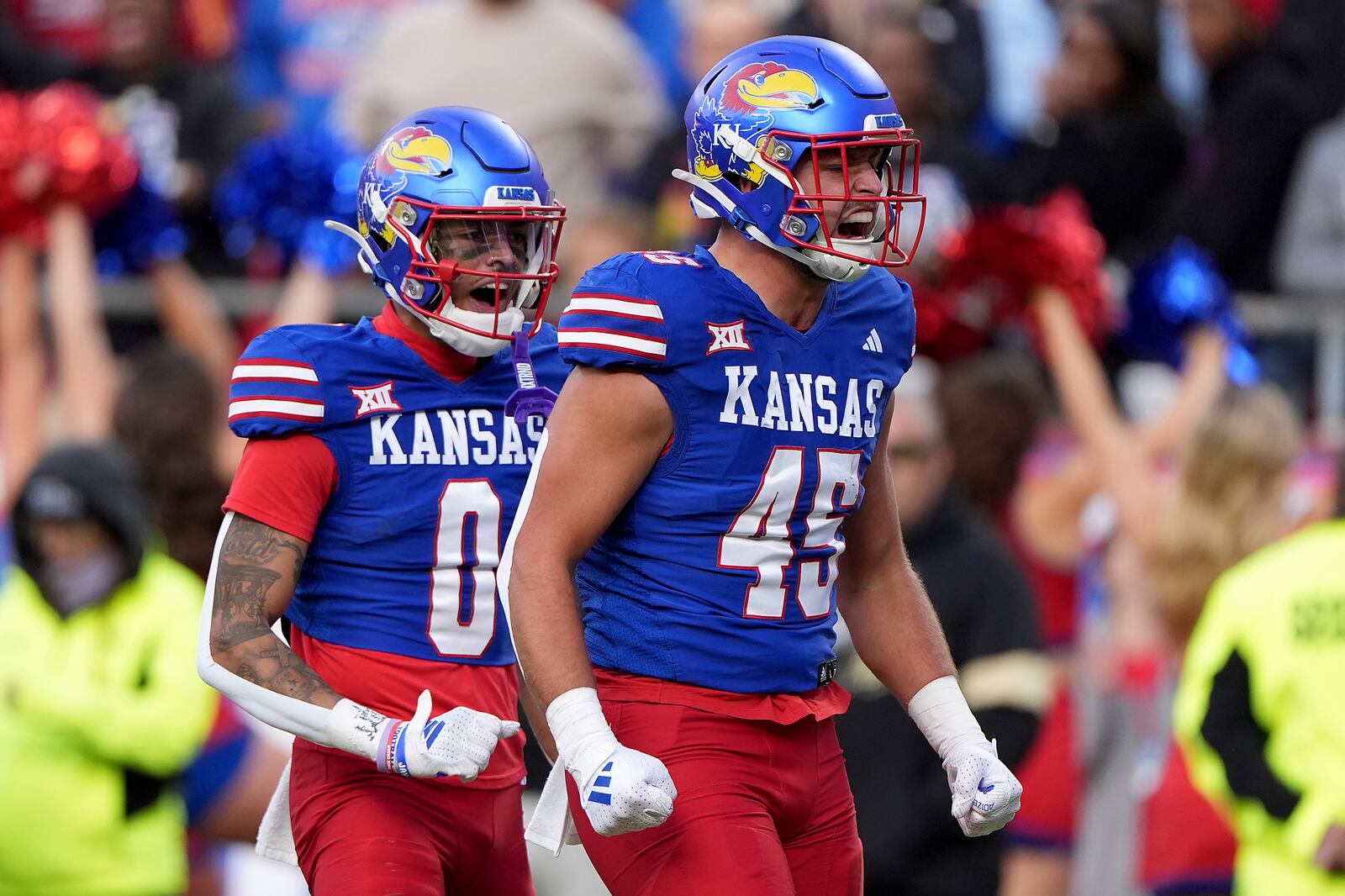 Kansas tight end Trevor Kardell (45) and wide receiver Quentin Skinner (0) celebrate after Kardell made a first down during the first half of an NCAA college football game Saturday, Nov. 23, 2024, in Kansas City, Mo. (AP Photo/Charlie Riedel)