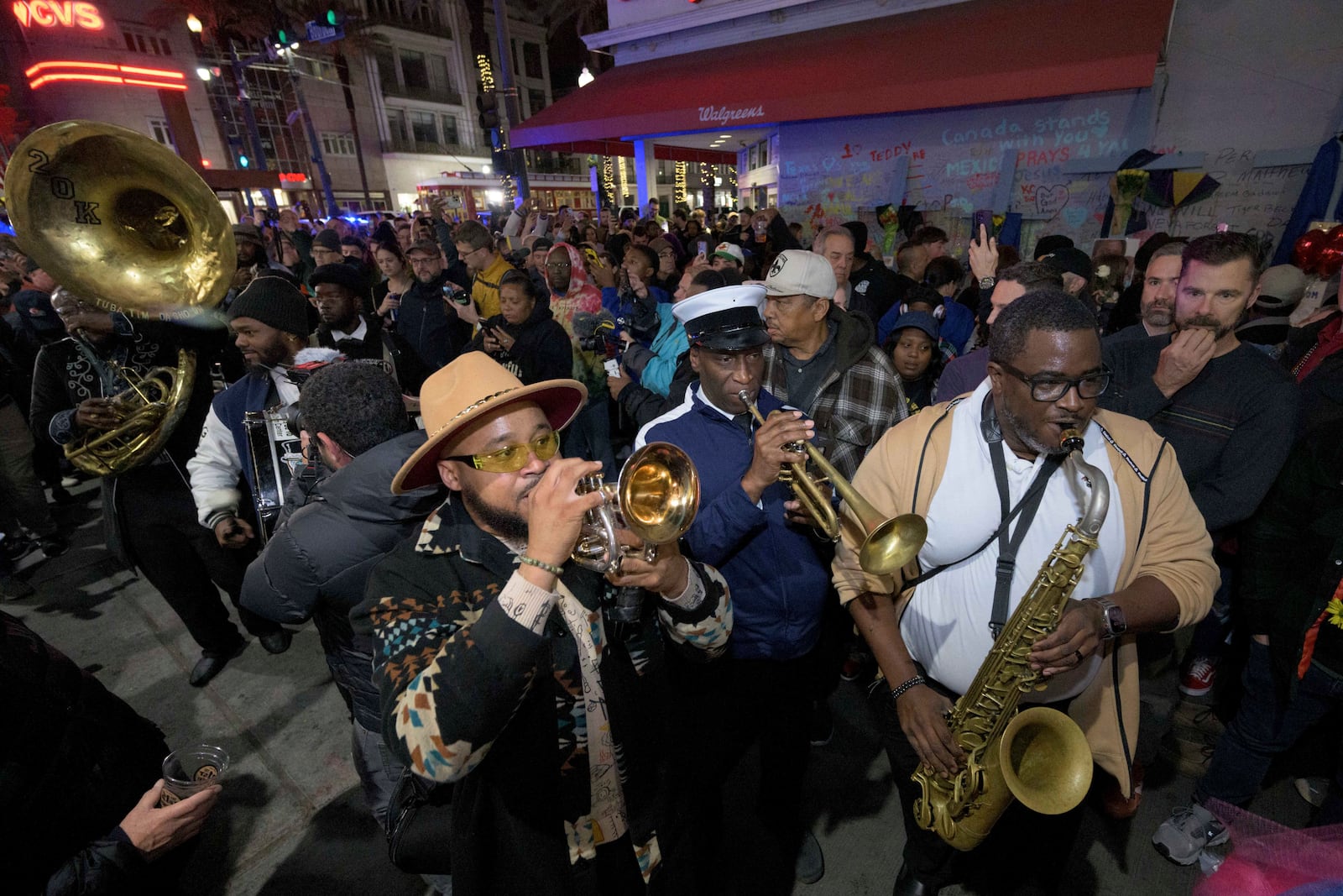 Amir "Tubad" Gray, front left, leads Tubad and the Kings of NOLA Brass Band in New Orleans, Saturday, Jan. 4, 2025, as they memorialize the victims of the New Year's Day deadly truck attack and shooting. Playing saxophone is Corey Hosey, trumpet is Kenneth Hagans, bass drum is Walter Kimble, and sousaphone is Timothy Brown. (AP Photo/Matthew Hinton)