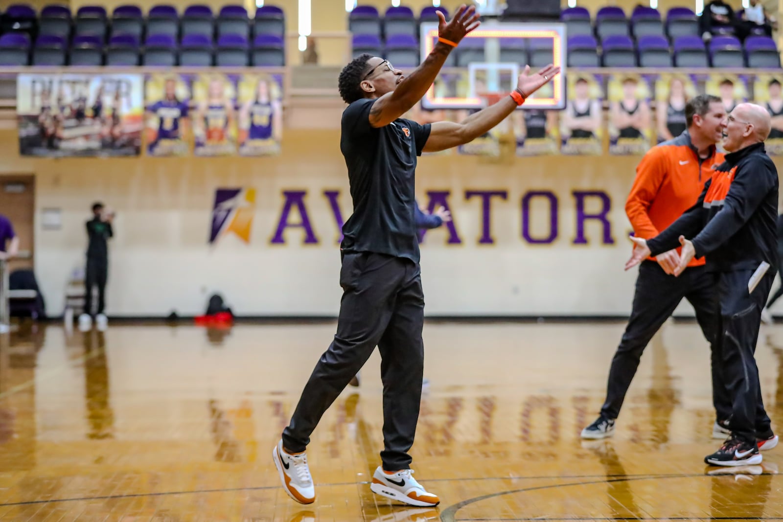 Beavercreek High School coach Isaiah Williams celebrates after beating Princeton 49-43 on Saturday afternoon at the Vandalia Butler Student Activities Center. The Beavers boys basketball team won their first district title since 2000. MICHAEL COOPER/STAFF