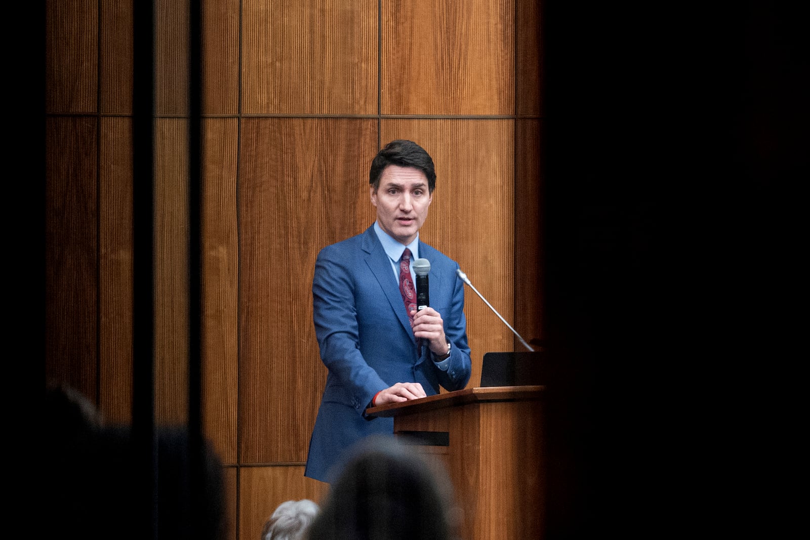 FILE - Canada's Prime Minister Justin Trudeau is pictured through glass as he speaks with members of his caucus in Ottawa, Ontario, on Dec. 16, 2024. (Spencer Colby/The Canadian Press via AP, File)