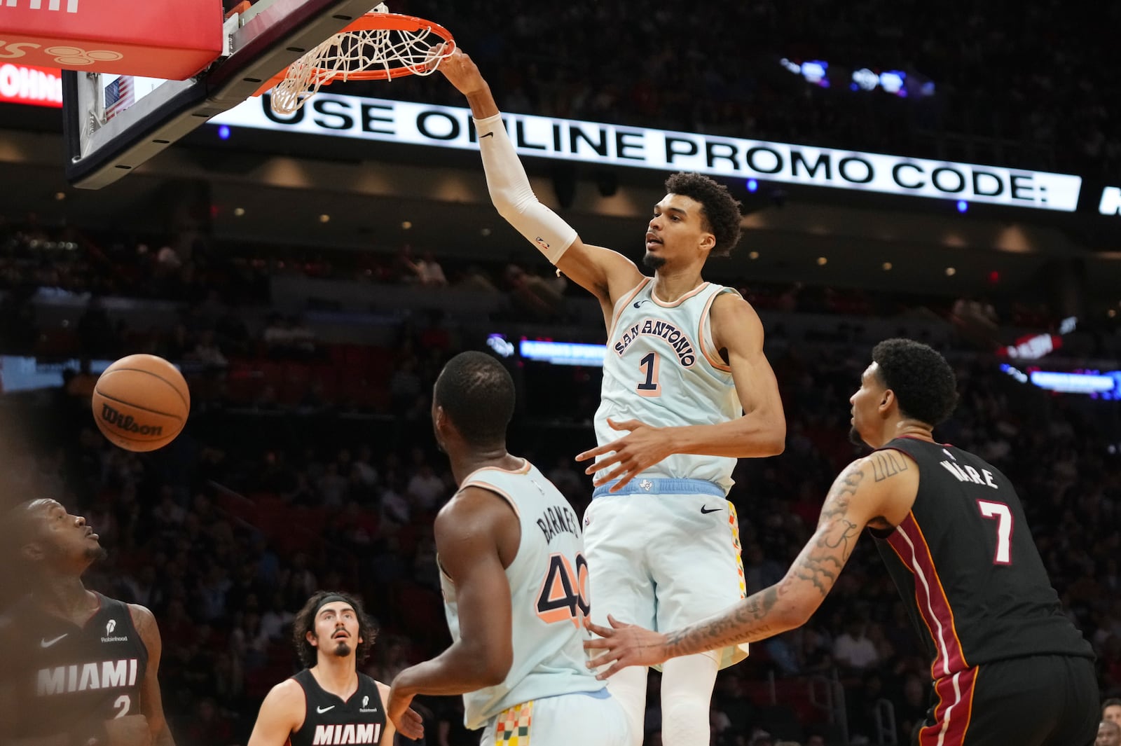 San Antonio Spurs center Victor Wembanyama (1) dunks over Miami Heat center Kel'el Ware (7) during the second half of an NBA basketball game, Sunday, Jan. 19, 2025, in Miami. (AP Photo/Lynne Sladky)