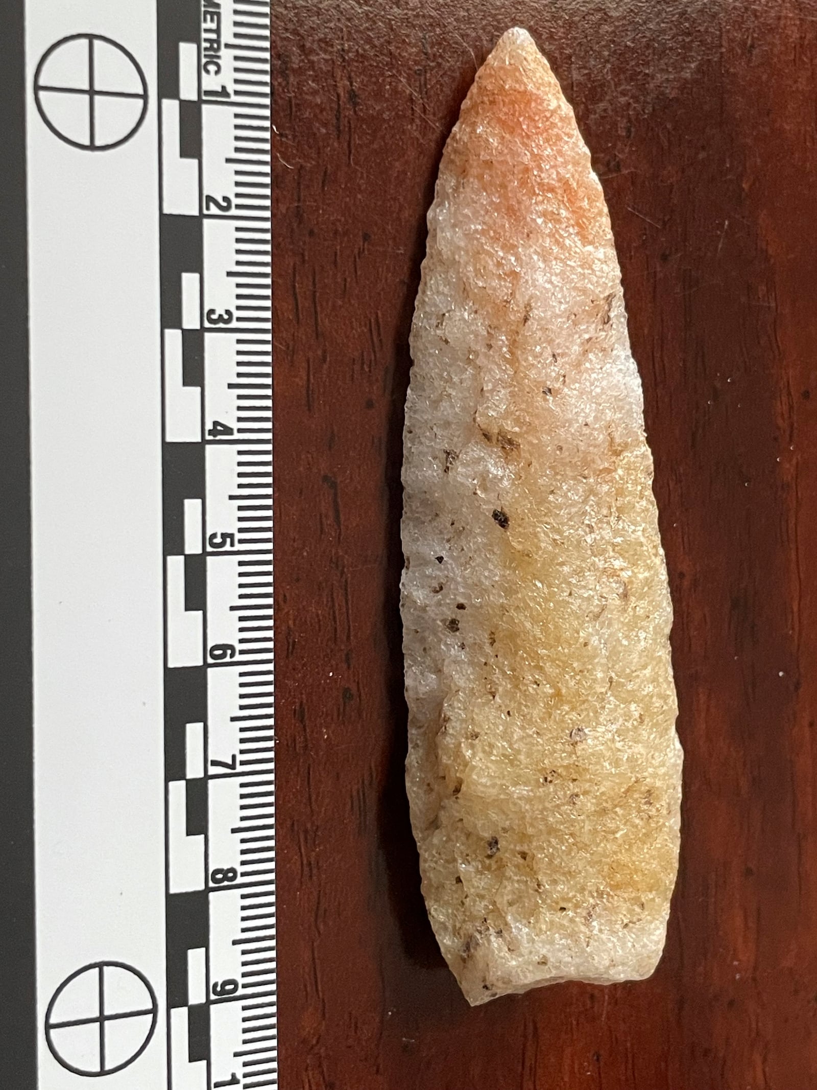 This undated photo provided by Philip LaPorta shows a Guilford style projectile point fashioned thousands of years ago from heat treated quartz mylonite that was uncovered during an archaeological survey of the Seniard Creek Fire scar south of Asheville, North Carolina. (Philip LaPorta via AP)