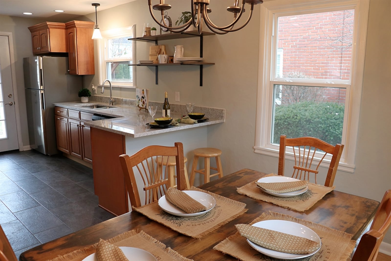 Aside from the flooring treatment, two peninsula counters divide the dining area from the redesigned kitchen.