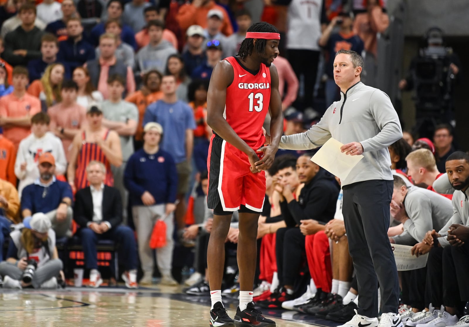 Georgia forward Dylan James (13) talks with head coach Mike White during the first half an NCAA college basketball game against Auburn, Saturday, Feb. 22, 2025, in Auburn, Ala. (AP Photo/Julie Bennett)