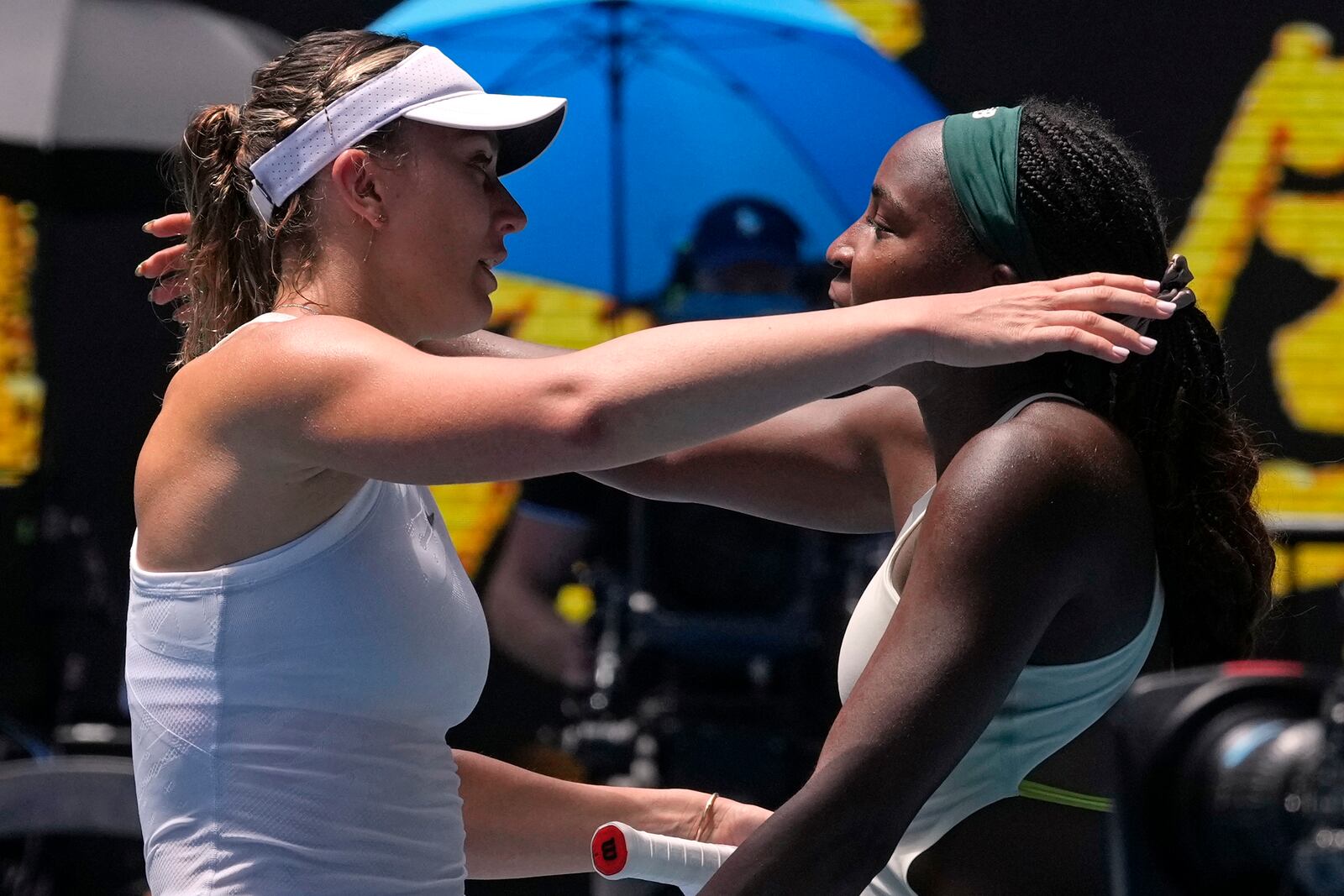 Paula Badosa, left, of Spain is congratulated by Coco Gauff of the U.S. following their quarterfinal match at the Australian Open tennis championship in Melbourne, Australia, Tuesday, Jan. 21, 2025. (AP Photo/Manish Swarup)