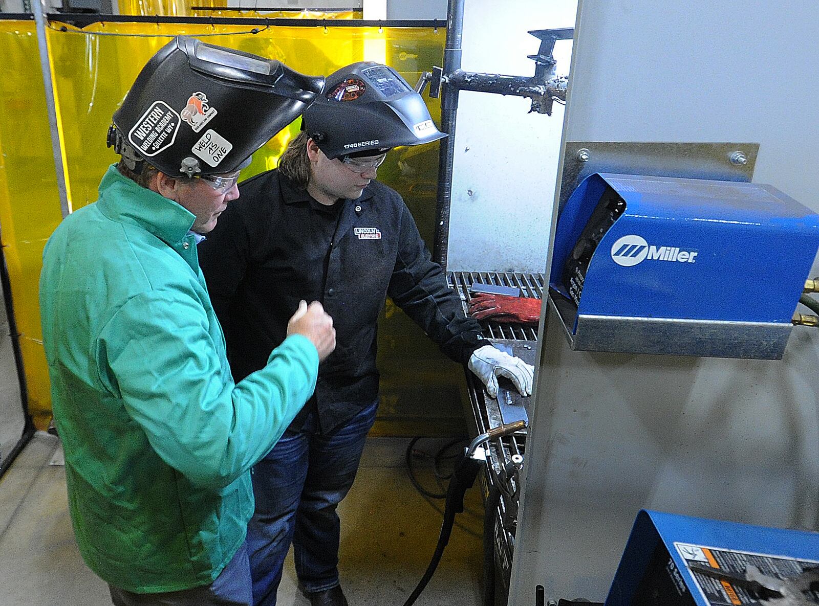 Ohio Lt. Gov. Jon Husted (left) gets a lesson in welding Thursday, May 9, 2024 from Greene County Career Center student Rylan Snyder. MARSHALL GORBY\STAFF