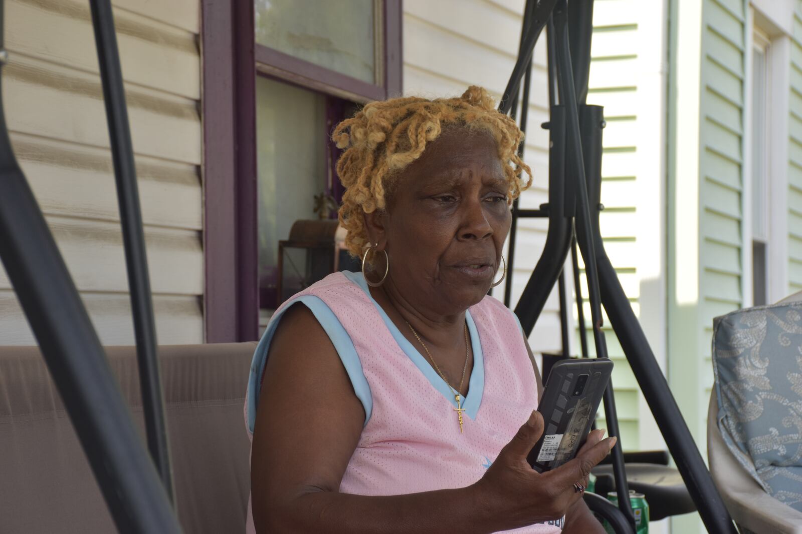 Annette Gibson-Strong, 65, on her front porch of her home on Hopeland Street in Dayton's Carillon neighborhood. Gibson-Strong opposes new recovery housing that will be built in her neighborhood. CORNELIUS FROLIK / STAFF