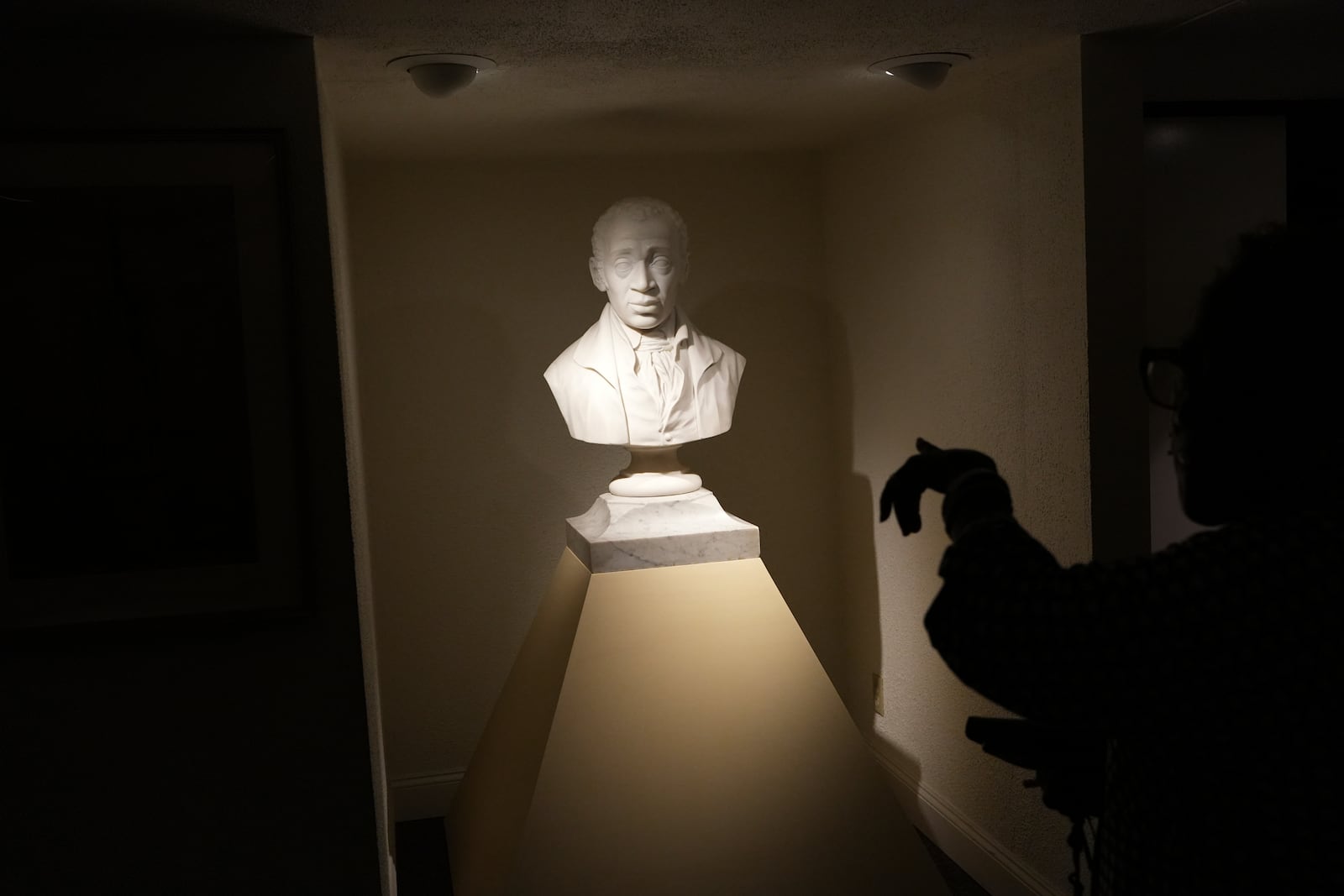 Mother Bethel AME Church member, Wanda Davis, points to a bust of the church’s founder, the Rev. Richard Allen, at the church museum in Philadelphia, on Sunday, Sept. 29, 2024. (AP Photo/Luis Andres Henao)