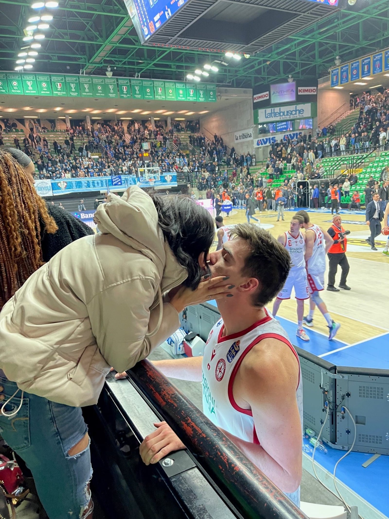 Abigail and A.J Pacher share a kiss after a game in Treviso when he was playing for Pallacanestro Trieste. CONTRIBUTED