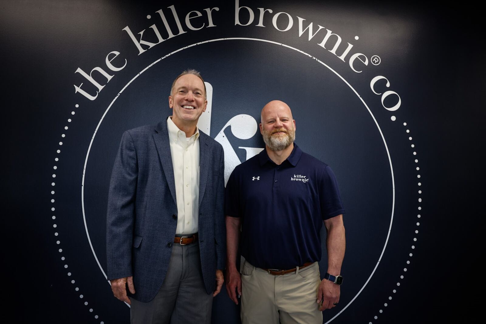 Executive director of the University of the Dayton's fastlane organization Phil Ratermann, left and Killer Brownies C.O.O. Matt Ross at Killer Brownie's Precision Court location in Miamisburg. JIM NOELKER/STAFF