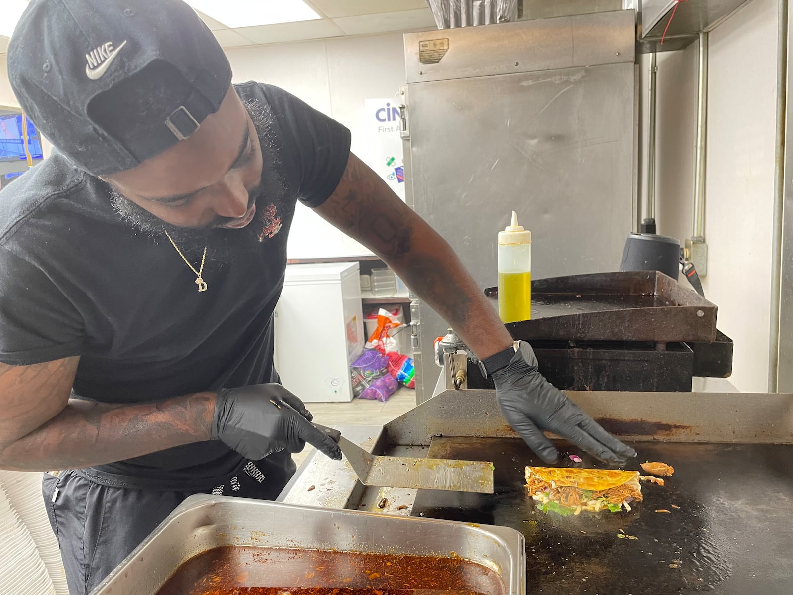 More Than A Apron in Miamisburg features Birria tacos made with beef, chicken or lamb, as well as birria bowls, fries and mac and cheese. Pictured is owner Darion Lewis. NATALIE JONES/STAFF