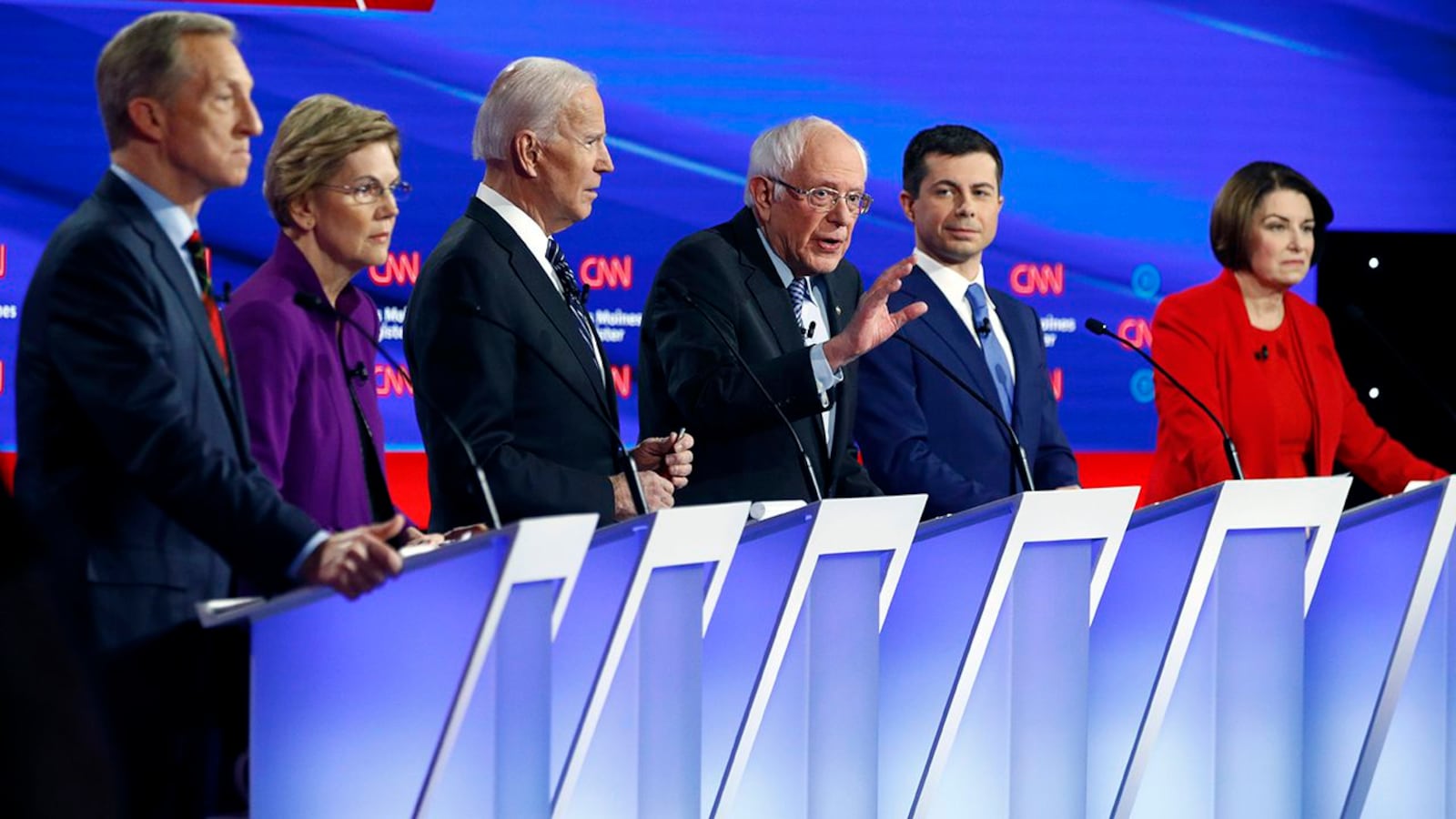 Democratic presidential candidate Sen. Bernie Sanders, I-Vt., center, speaks as fellow candidates businessman Tom Steyer, from left, Sen. Elizabeth Warren, D-Mass., former Vice President Joe Biden, former South Bend Mayor Pete Buttigieg and Sen. Amy Klobuchar, D-Minn. listen, Tuesday, Jan. 14, 2020, during a Democratic presidential primary debate hosted by CNN and the Des Moines Register in Des Moines, Iowa. (AP Photo/Patrick Semansky)