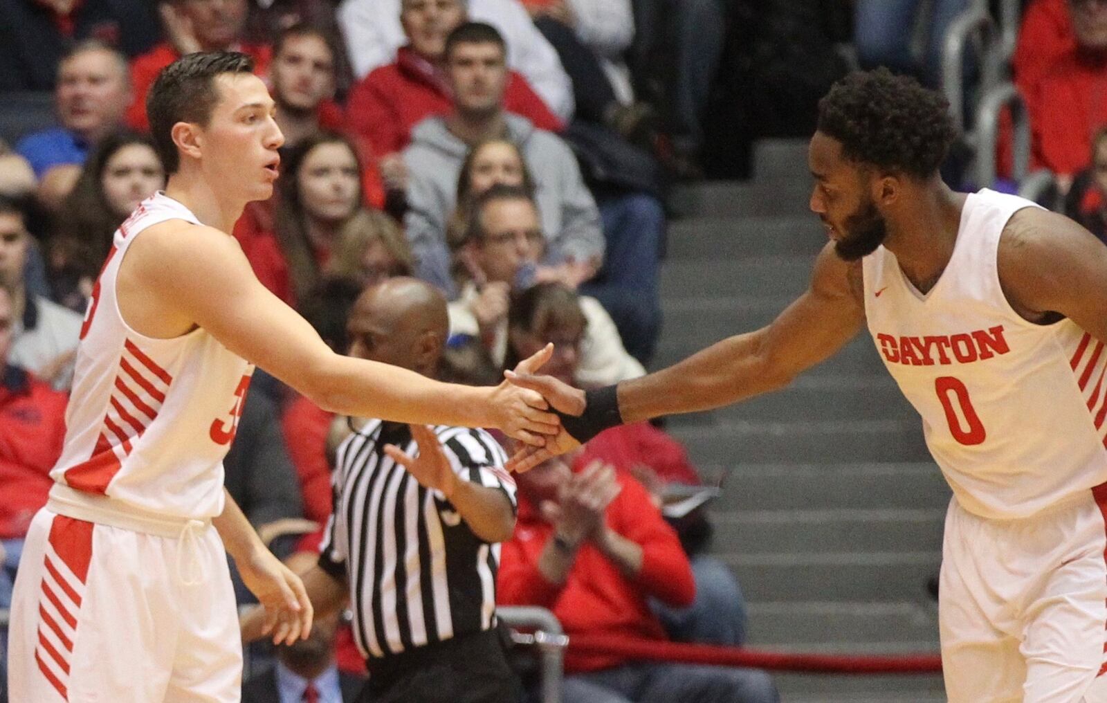 Dayton’s Ryan Mikesell and Josh Cunningham slap hands after a stop against Western Michigan on Wednesday, Dec. 19, 2018, at UD Arena. David Jablonski/Staff