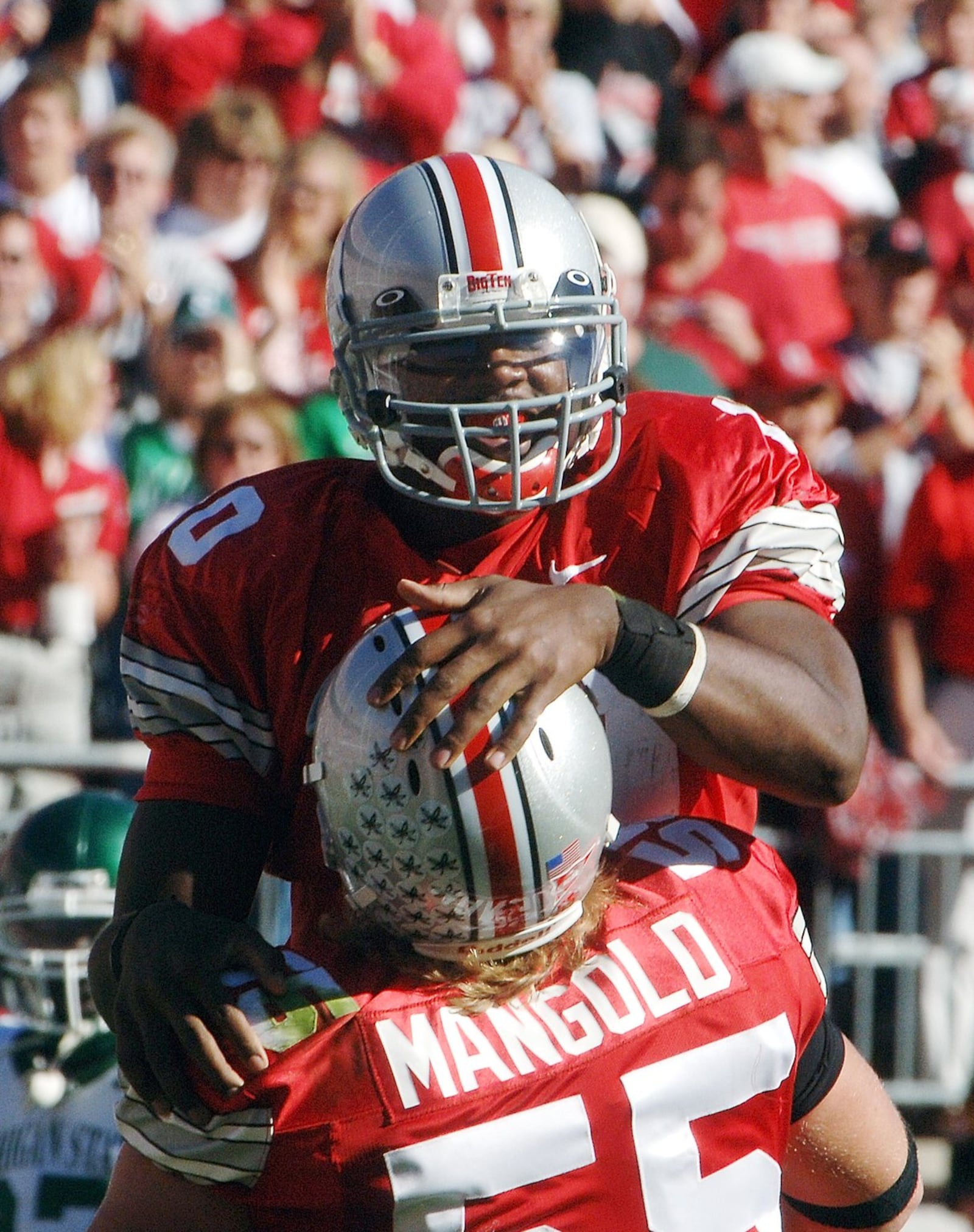 Ohio State quarterback Troy Smith (10) celebrates his fourth quarter touchdown against Michigan State with teammate Nick Mangold (55) Saturday, Oct. 15, 2005 at the Ohio Stadium in Columbus, Ohio. Ohio State beat Michigan, 35-24. (AP Photo/Mark Hall)