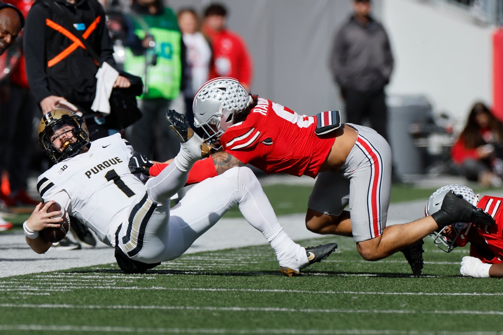 Ohio State defensive back Lathan Ransom, right, forces Purdue quarterback Hudson Card out of bounds during the first half of an NCAA college football game Saturday, Nov. 9, 2024, in Columbus, Ohio. (AP Photo/Jay LaPrete)