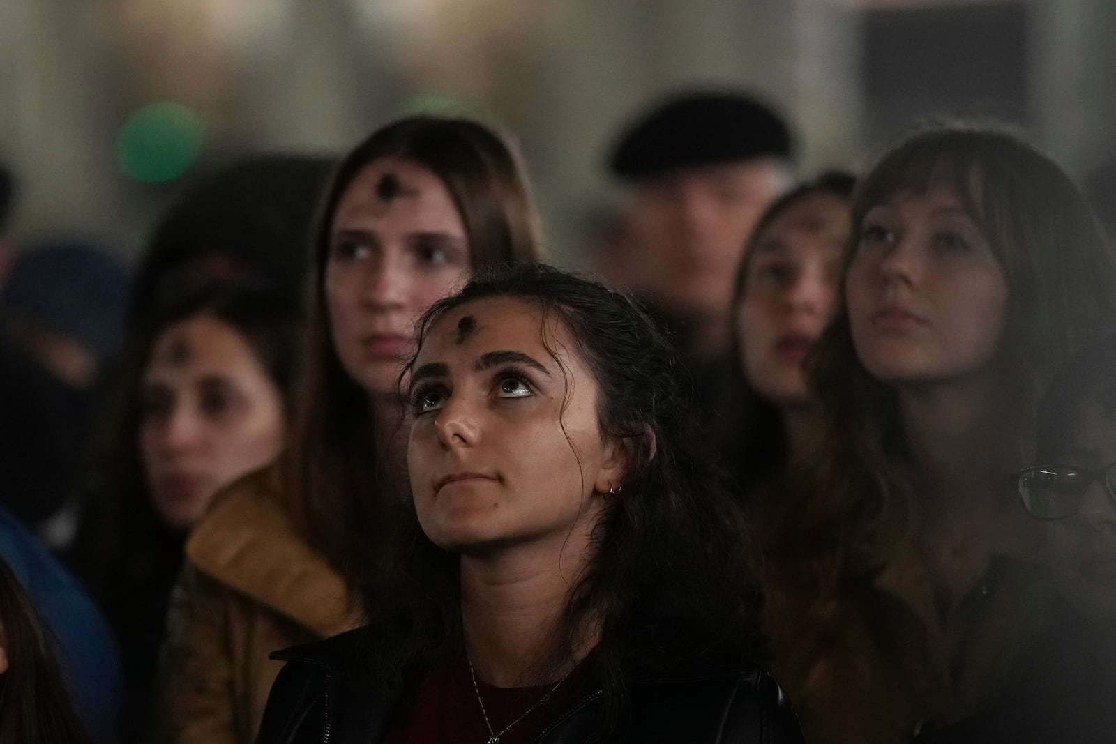 Girls, with ashes on their foreheads, pray during a rosary prayer for Pope Francis' health in St. Peter's Square at the Vatican, Wednesday, March 5, 2025. (AP Photo/Alessandra Tarantino)