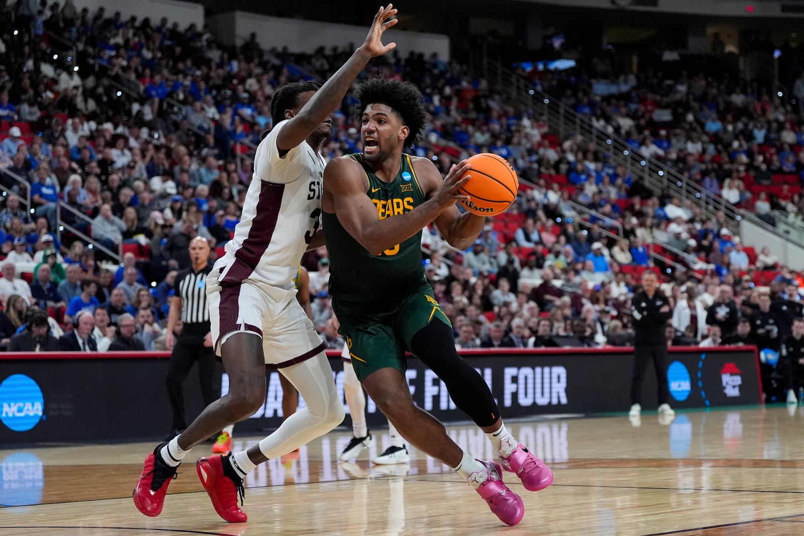 Baylor forward Norchad Omier (15) drives toward the basket past Mississippi State forward KeShawn Murphy (3) during the second half in the first round of the NCAA college basketball tournament, Friday, March 21, 2025, in Raleigh, N.C. (AP Photo/Stephanie Scarbrough)