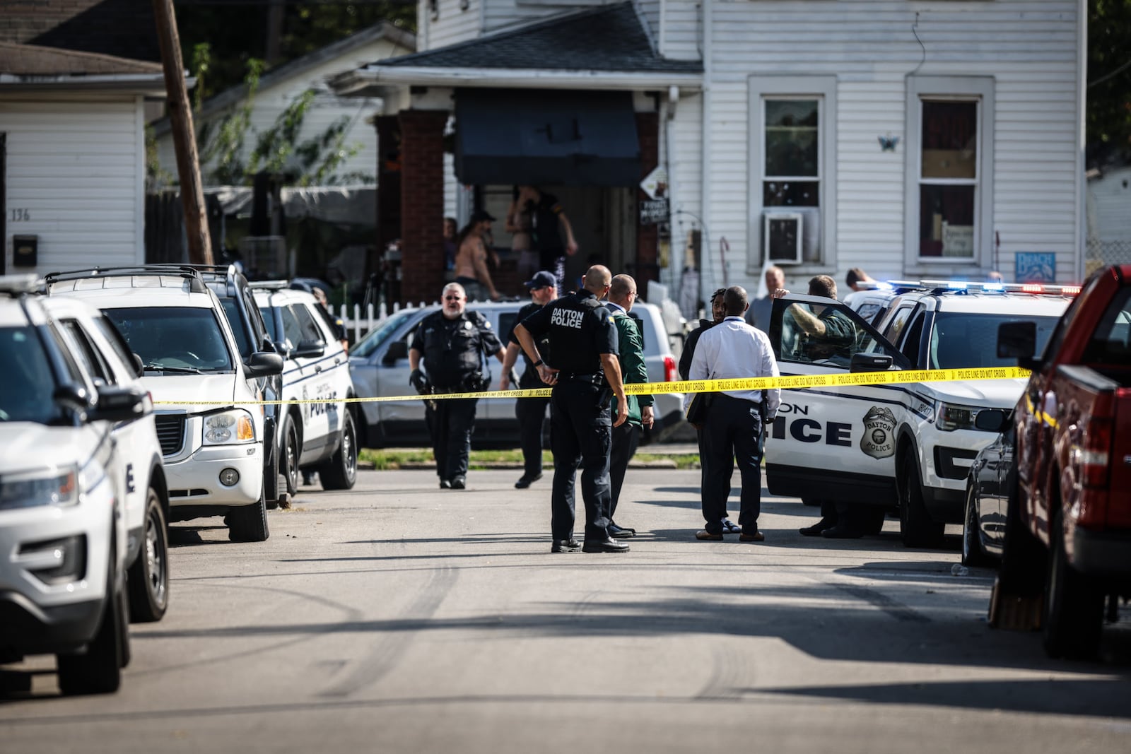 Dayton police were called to a shooting on Caho Street Monday, Oct. 11, 2021. A woman was taken to the hospital with life-threatening injuries, according to police. JIM NOELKER / STAFF