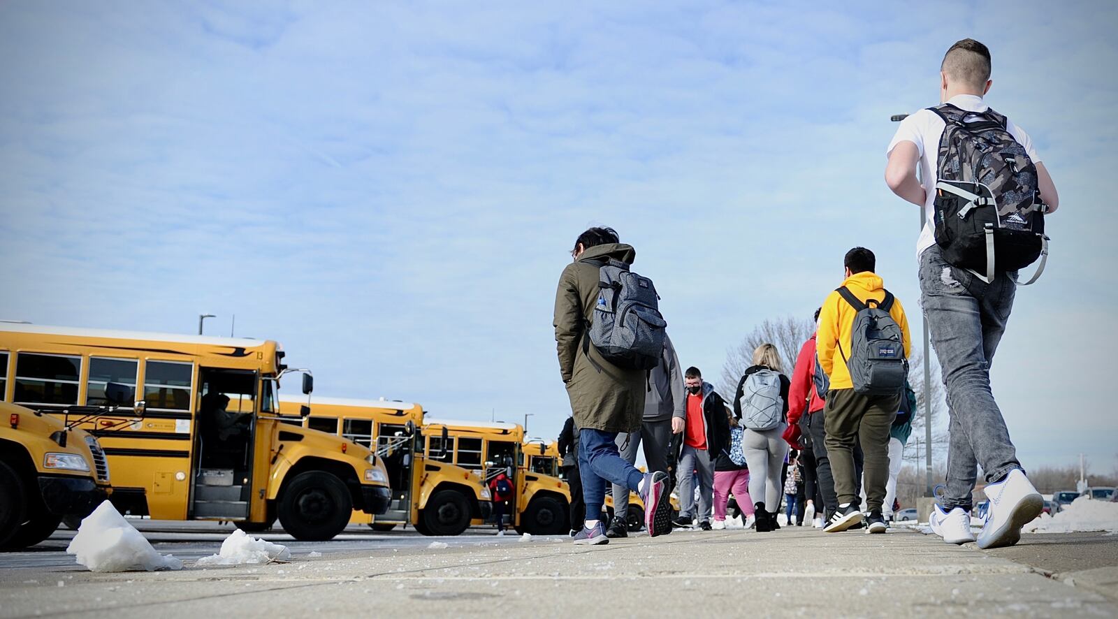 Stebbins high school students prepare to board buses after their first day back to school Tuesday, Jan. 18, 2022. Starting in the new school year, some Stebbins staff will have access to guns in the school. MARSHALL GORBY \STAFF