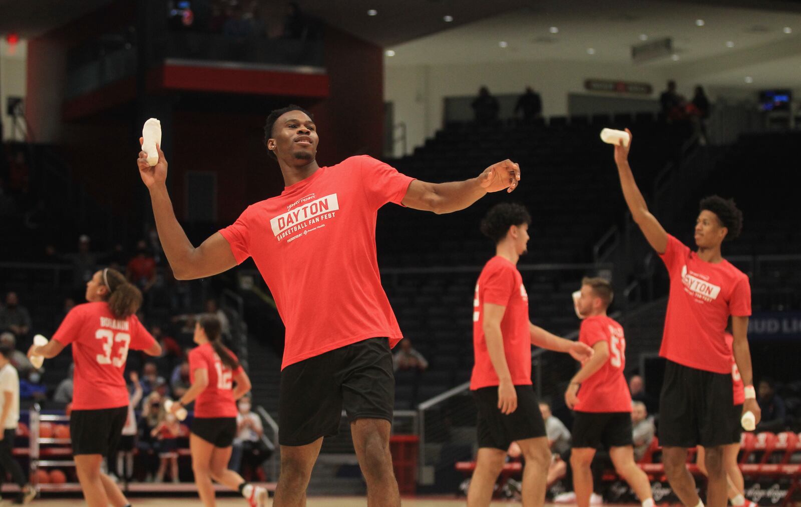 Dayton's Richard Amaefule throws a T-shirt into the stands at the Dayton Basketball Fan Fest on Saturday, Oct. 16, 2021, at UD Arena. David Jablonski/Staff