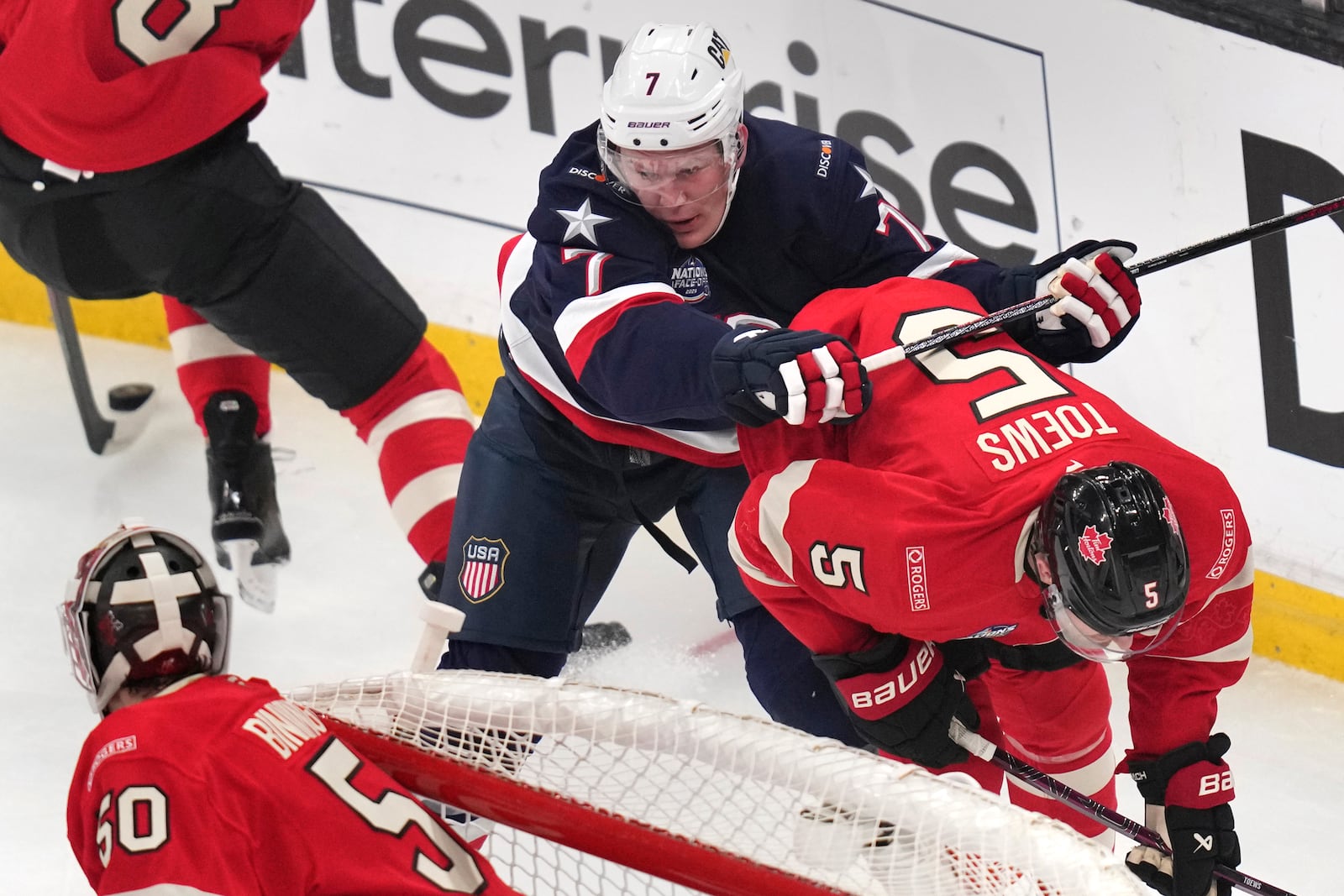 United States' Brady Tkachuk checks Canada's Devon Toews (5) during the first period of the 4 Nations Face-Off championship hockey game, Thursday, Feb. 20, 2025, in Boston. (AP Photo/Charles Krupa)