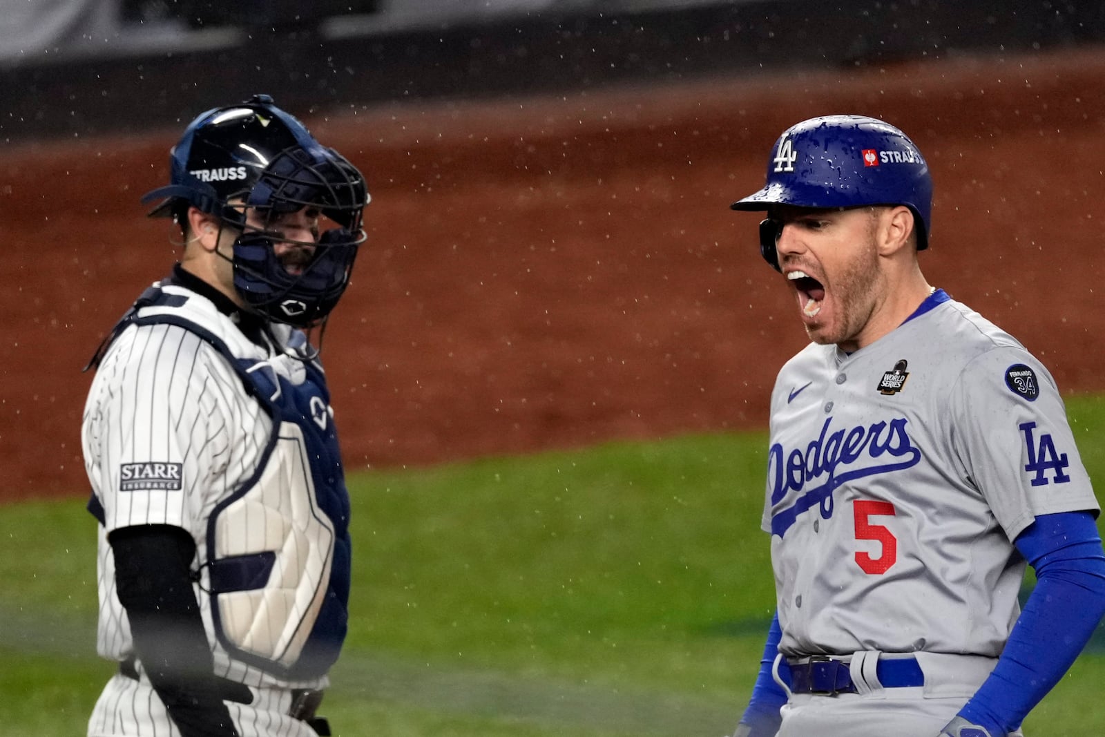 Los Angeles Dodgers' Freddie Freeman (5) celebrates after hitting a two-run home run as New York Yankees catcher Austin Wells watches during the first inning in Game 4 of the baseball World Series, Tuesday, Oct. 29, 2024, in New York. (AP Photo/Seth Wenig)