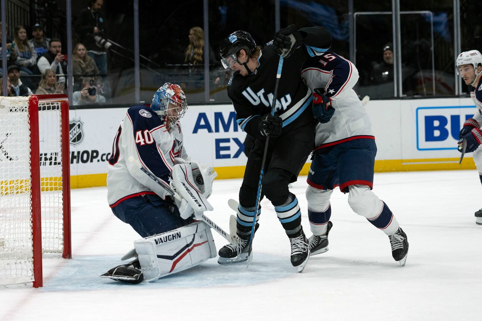 Columbus Blue Jackets goaltender Daniil Tarasov (40) saves the puck against Utah Hockey Club center Clayton Keller, center, during the first period of an NHL hockey game Friday, Jan. 31, 2025, in Salt Lake City. (AP Photo/Melissa Majchrzak)