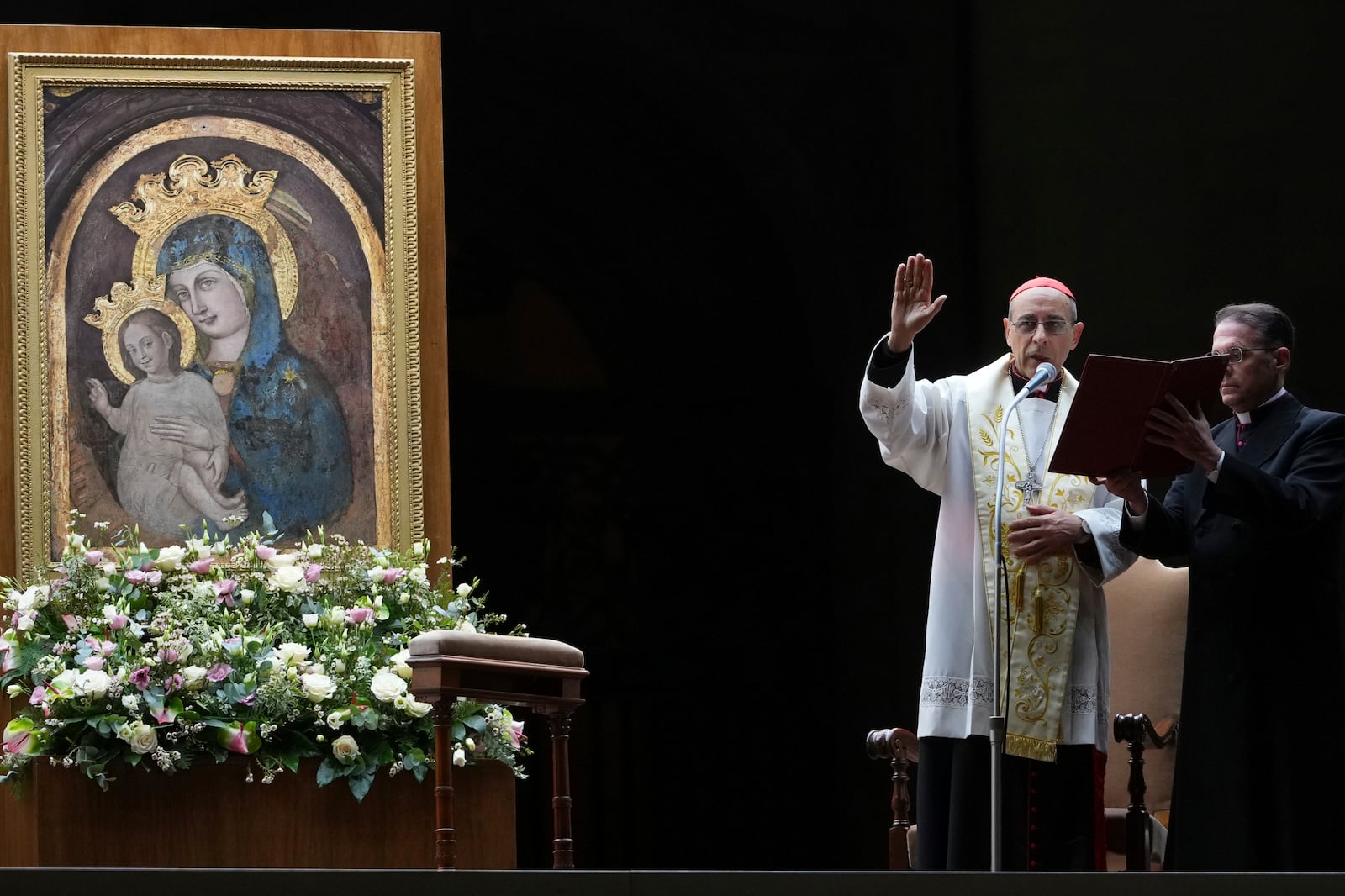 Cardinal Victor Manuel Fernandez, left, prays during a rosary prayer held for the health of Pope Francis in St Peter's Square at The Vatican, Friday, Feb. 28, 2025. (AP Photo/Kirsty Wigglesworth)