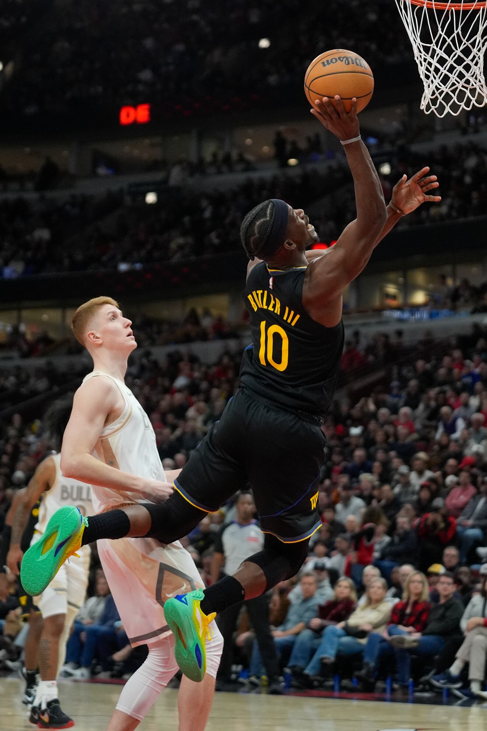 Golden State Warriors forward Jimmy Butler (10) goes up to shoot during the second half of an NBA basketball game against the Chicago Bulls, Saturday, Feb. 8, 2025, in Chicago. (AP Photo/Erin Hooley)