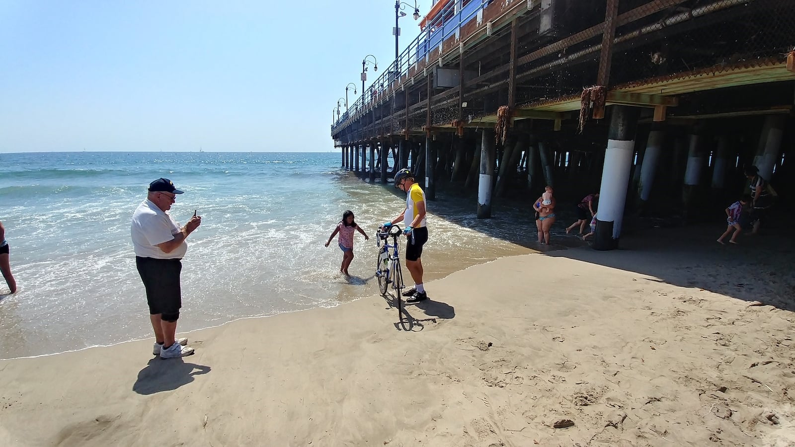 Kettering resident Earl McDaniel will soon finish a bicycle ride across the U.S. Here, he dips his tire in the Pacific Ocean in September 2018 as part of that trek. CONTRIBUTED