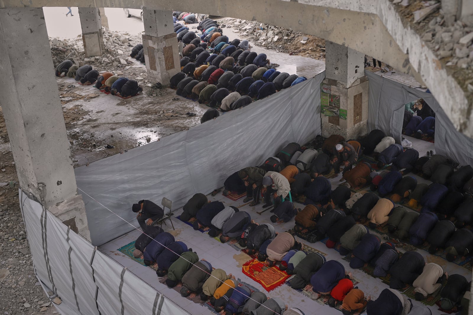 Palestinians pray during the first Friday prayers of the Muslim holy month of Ramadan at the Imam Shafi'i Mosque, damaged by Israeli army strikes, in the Zeitoun neighborhood in Gaza City, Friday March 7, 2025.(AP Photo/(AP Photo/Jehad Alshrafi)