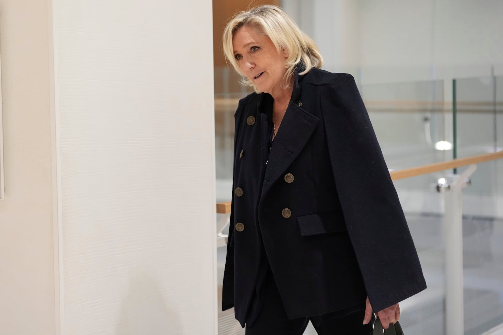 FILE - French far-right leader Marine Le Pen arrives at the courtroom for the trial over the suspected embezzlement of European Parliament funds, Wednesday, Nov. 6, 2024 in Paris. (AP Photo/Aurelien Morissard, File)