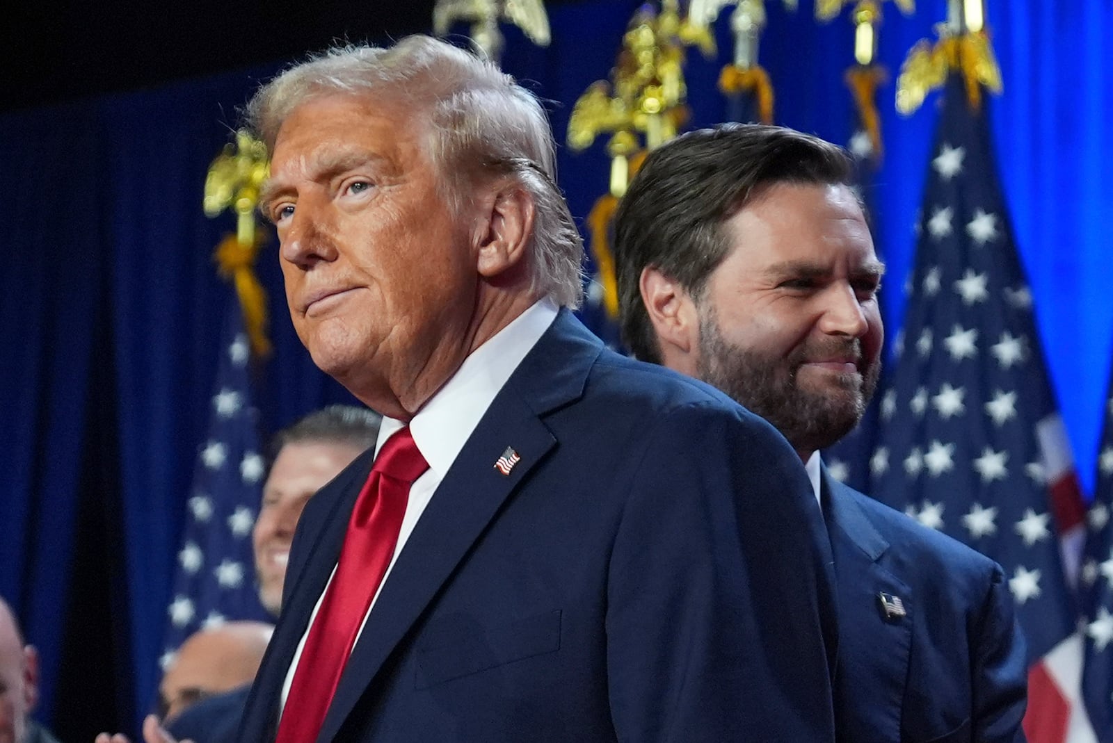 Republican presidential nominee former President Donald Trump and his running mate Sen. JD Vance, R-Ohio, stand on stage at an election night watch party at the Palm Beach Convention Center, Wednesday, Nov. 6, 2024, in West Palm Beach, Fla. (AP Photo/Evan Vucci)