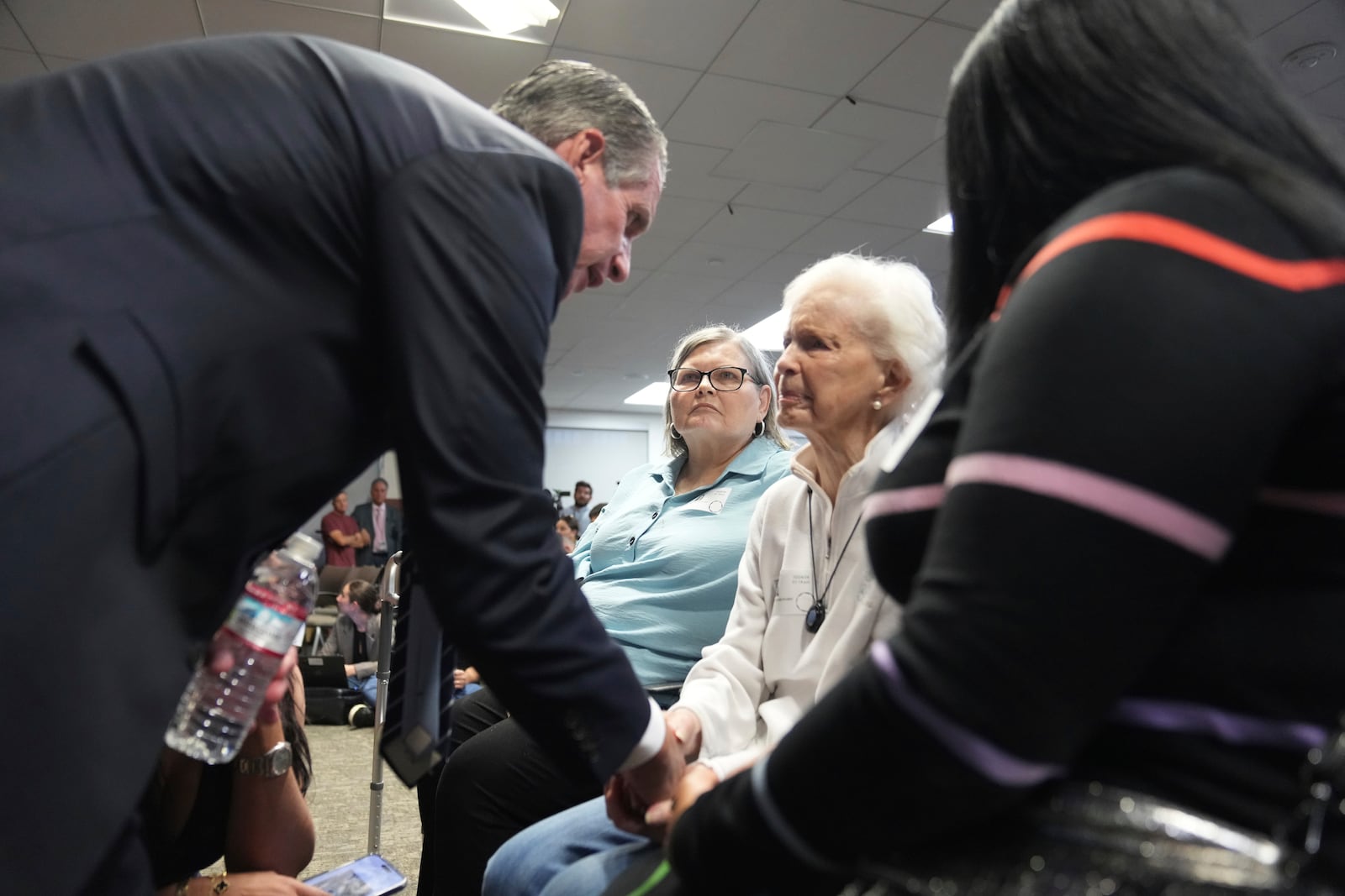 Family attorney Bryan Freedman, left greets Kitty Menendez's sister, Joan Andersen VanderMolen, center as Diane Hernandez niece of Kitty Menendez, left, looks on prior to a news conference being held by Los Angeles County District Attorney George Gascon at the Hall of Justice on Thursday, Oct. 24, 2024, in Los Angeles. (AP Photo/Eric Thayer)