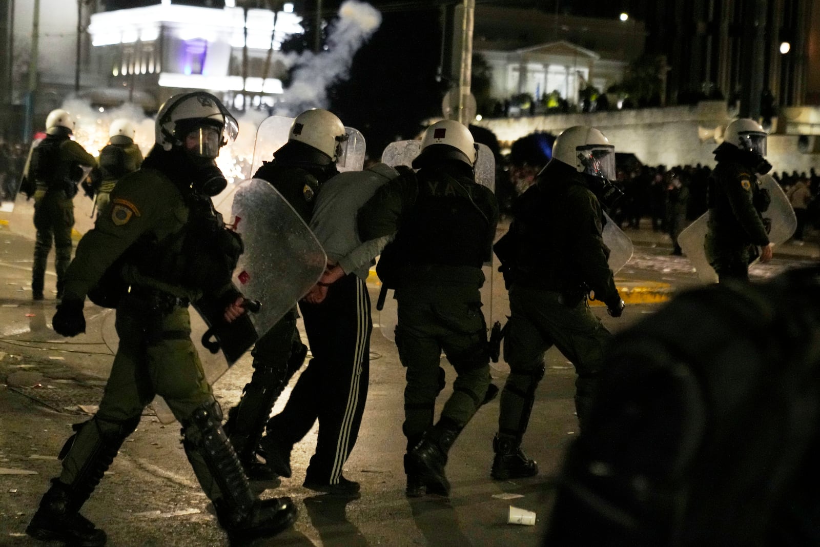 Riot policemen detain a protester during a rally, after the Greek opposition parties have challenged the country's center-right government with a censure motion in parliament over a devastating rail disaster nearly two years ago, in Athens, Wednesday, March 5, 2025. (AP Photo/Petros Giannakouris)