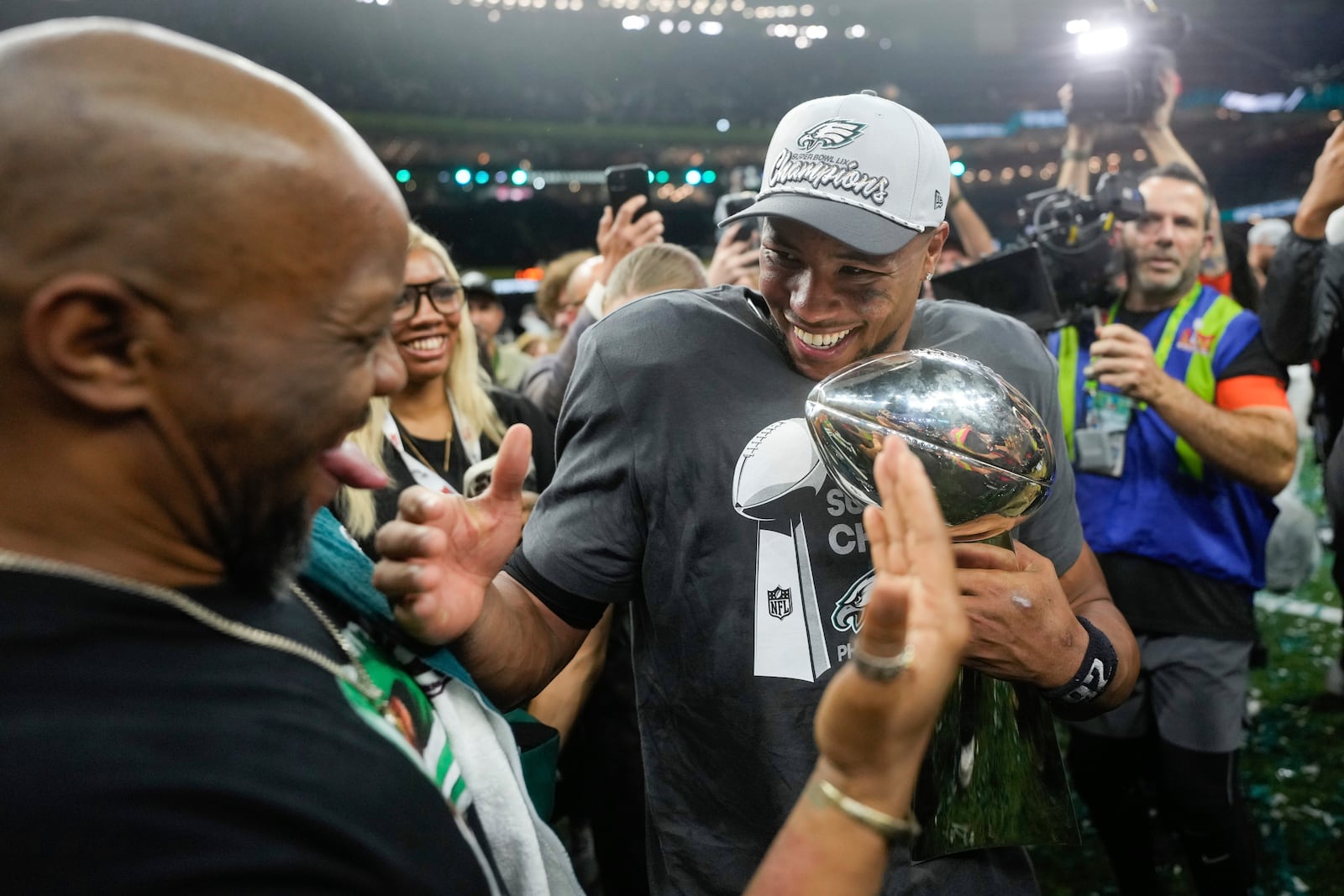 Philadelphia Eagles running back Saquon Barkley celebrates with the Vince Lombardi Trophy after a win over the Kansas City Chiefs in the NFL Super Bowl 59 football game, Sunday, Feb. 9, 2025, in New Orleans. (AP Photo/Matt Slocum)