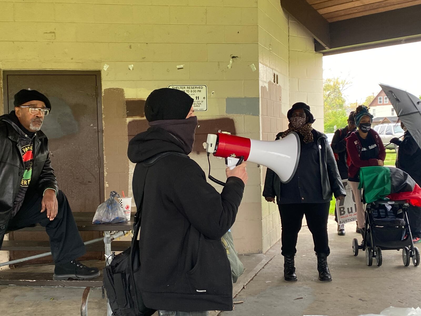 Fred Lambert, center, a community organizer and frequent protestor, speaks at a rally on Saturday, April 24 in Dayton View Park. New Black Panther local leader Donald Domineck looks on. Eileen McClory / Staff