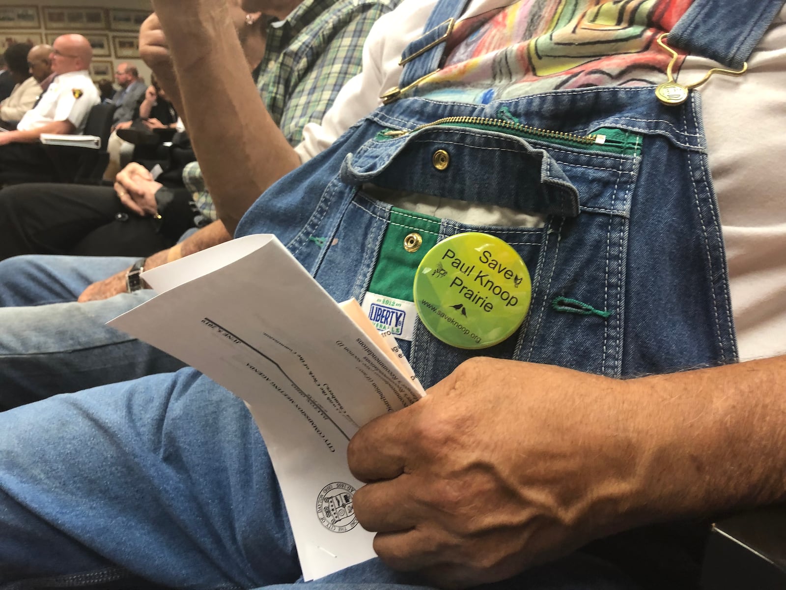 About 150 people attended a Dayton City Commission meeting in 2019, many of them to oppose redevelopment of the Paul E. Knoop Jr. Prairie near the Dayton International Airport. Some wore buttons that read, “Save Paul Knoop Prairie.” CORNELIUS FROLIK / STAFF