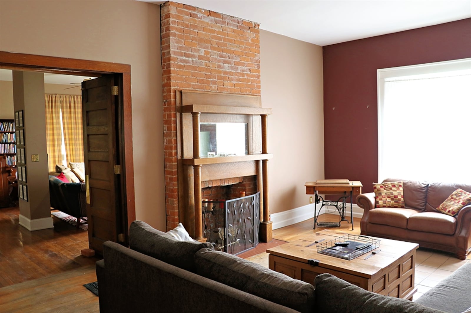 The other side of the shared brick fireplace is the focal point of the family room and has a pillar wood double mantel surround. 