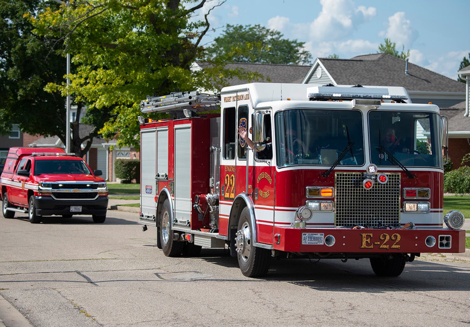 Firefighters and firetrucks belonging to the 788th Civil Engineer Squadron caravan through Wright-Patterson Air Force Base housing Aug. 3. The Fire Department took part in the annual National Night Out, an event designed to build police-community partnerships. U.S. AIR FORCE PHOTO/R.J. ORIEZ