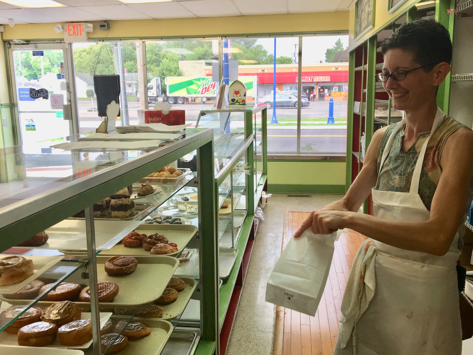 Jennifer Evans works in her family bakery in Old North Dayton. The business has hired individuals in recovery who live at Good Shepherd Ministries sober living homes. KATIE WEDELL/STAFF