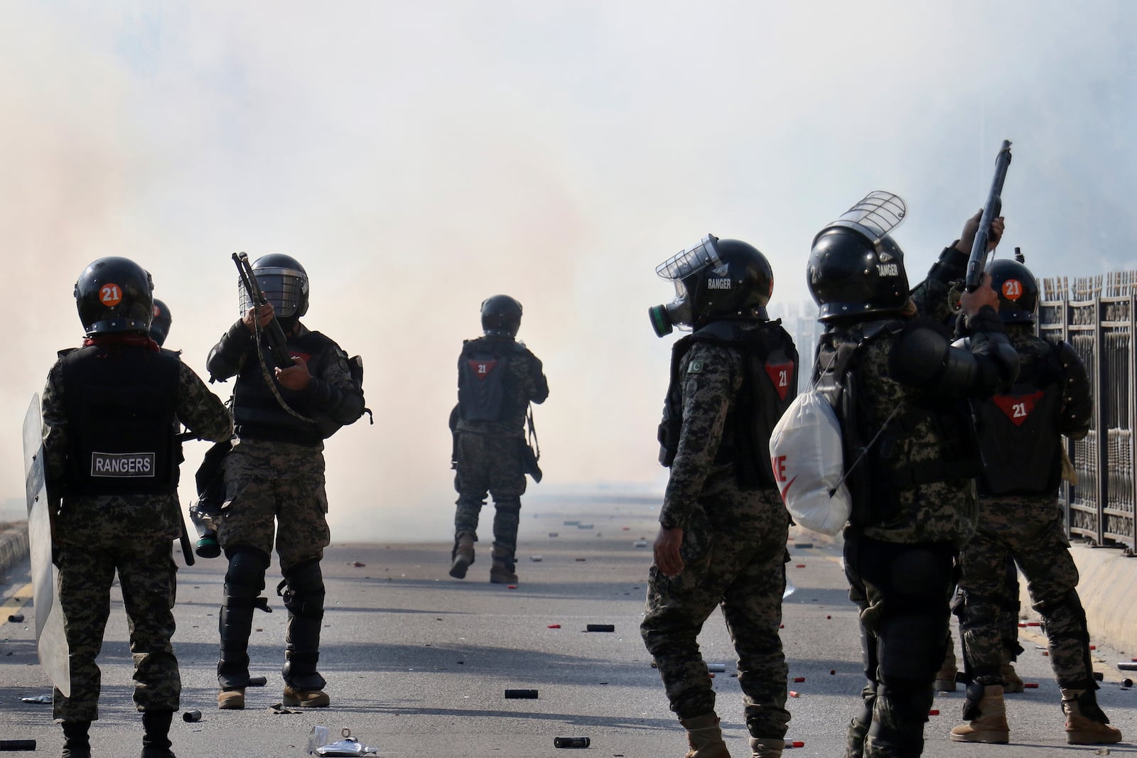 Paramilitary soldiers fire rubber bullets and tear gas shells to disperse supporters of imprisoned former premier Imran Khan's Pakistan Tehreek-e-Insaf party, during clashes at D-Chowk square close to Red Zone, which is an area that houses key government buildings, in Islamabad, Pakistan, Tuesday, Nov. 26, 2024. (AP Photo/Ehsan Shahzad)