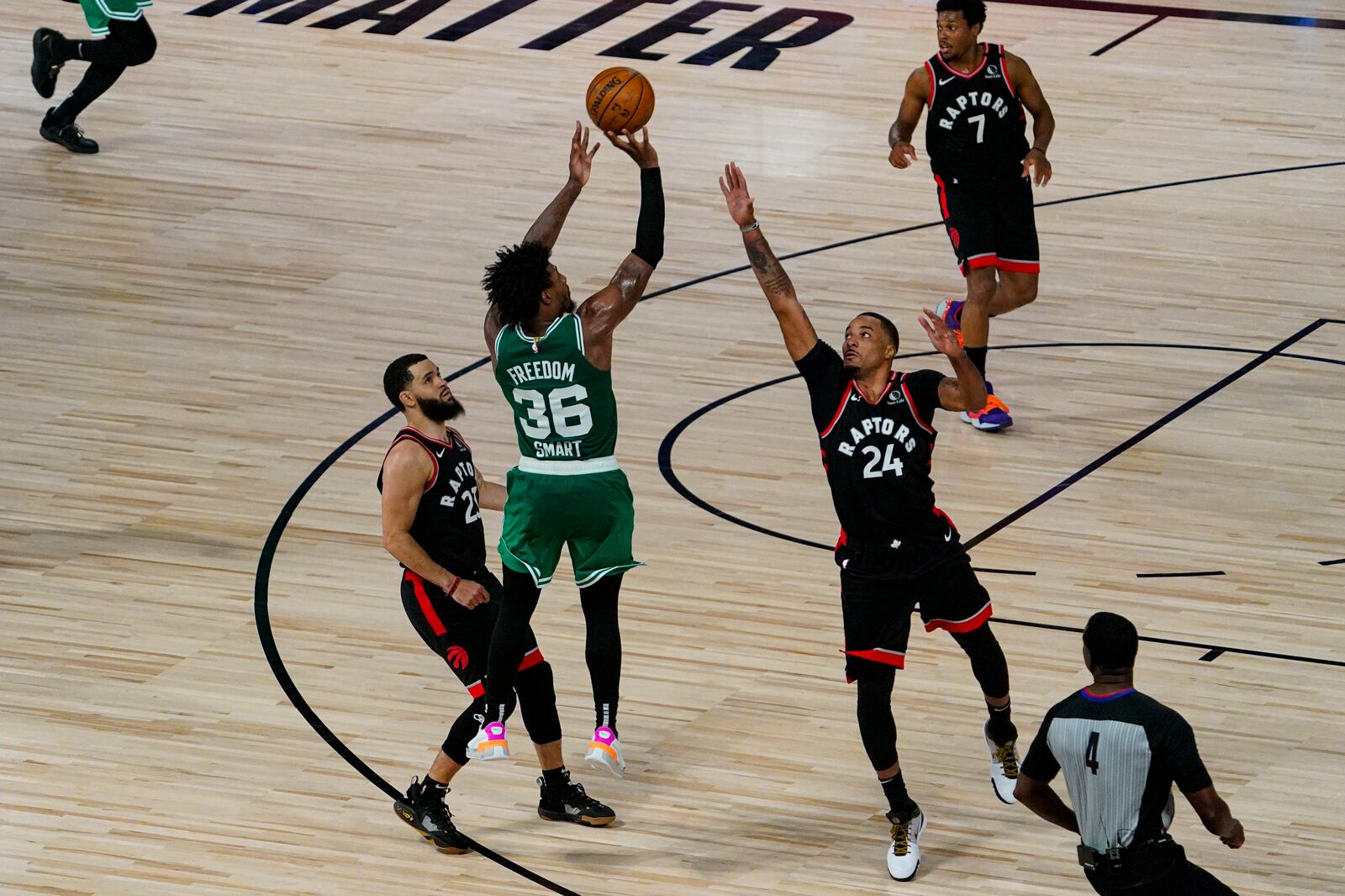 Boston Celtics guard Marcus Smart (36 misses a shot over over Toronto Raptors guard Norman Powell (24) with less a second remaining in the second overtime an NBA conference semifinal playoff basketball game Wednesday, Sept. 9, 2020, in Lake Buena Vista, Fla. (AP Photo/Mark J. Terrill)