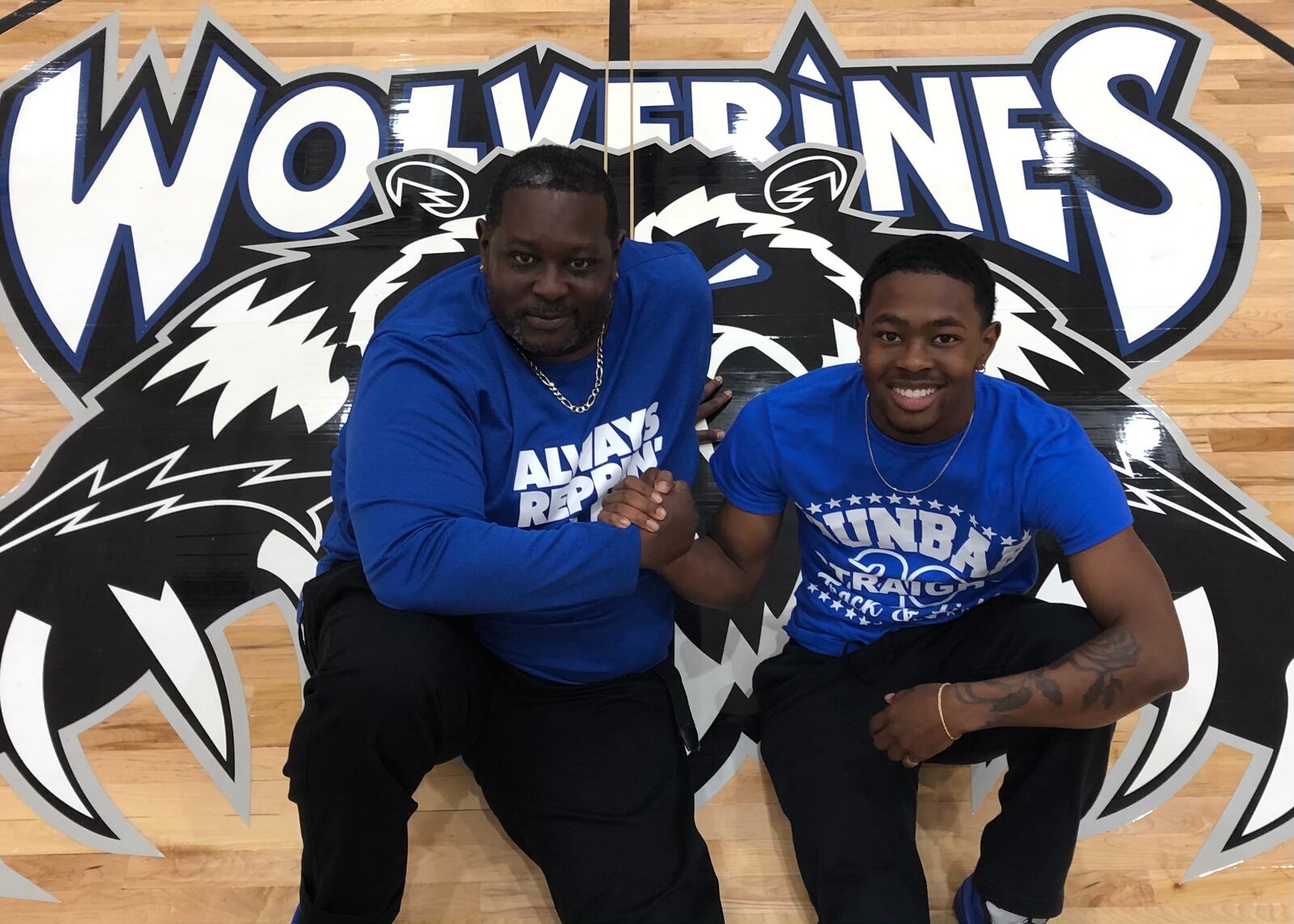 Dunbar High School valedictorian and athlete Myles Lacking poses with his father, James, who is an English teacher and football coach at the school. JEREMY P. KELLEY / STAFF